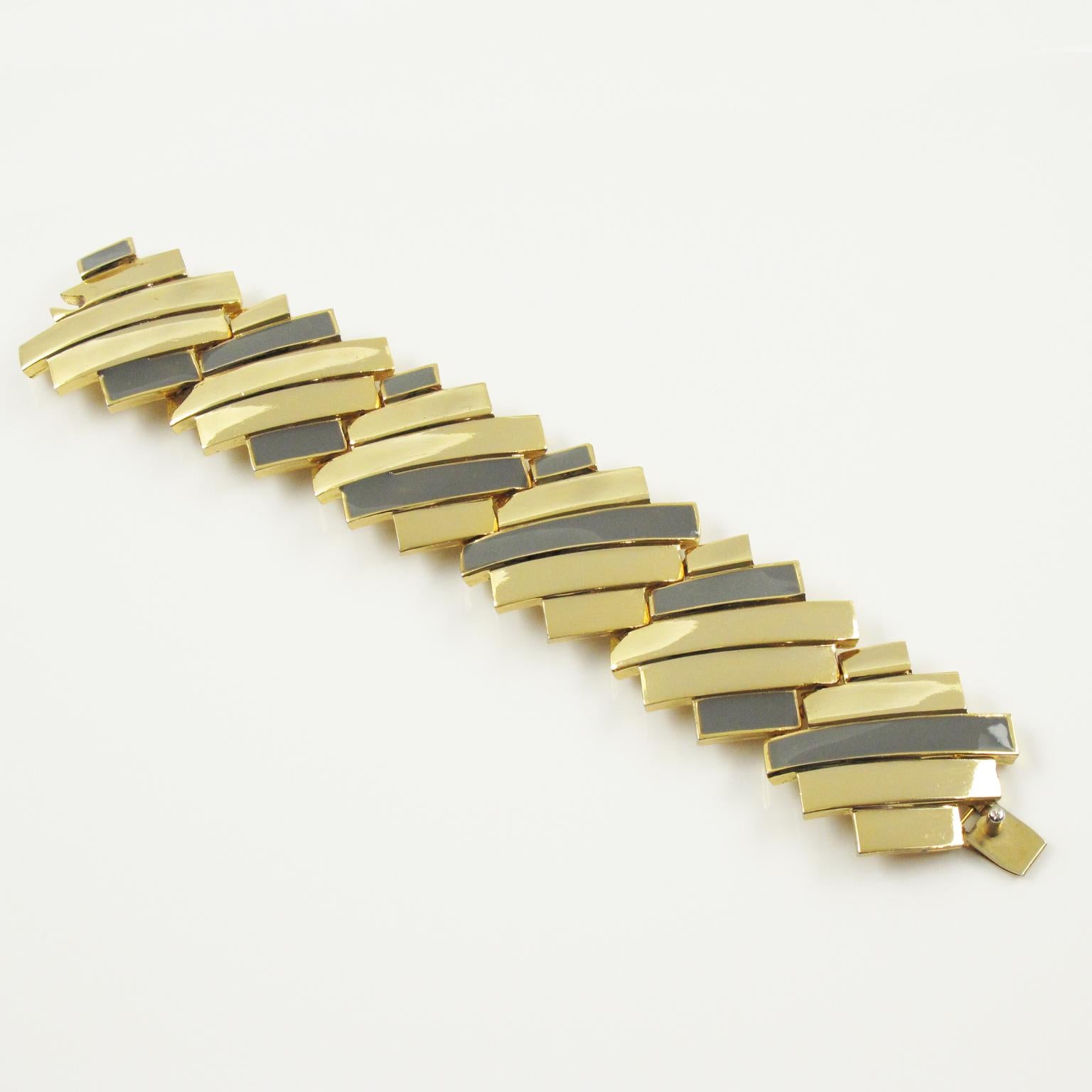 This elegant Lanvin Paris modernist link bracelet is a statement piece from the early 1970s featuring a massive gilded metal carved bangle in futuristic design compliments with gray enamel. The Lanvin Paris gilt tag is on the underside. The locking