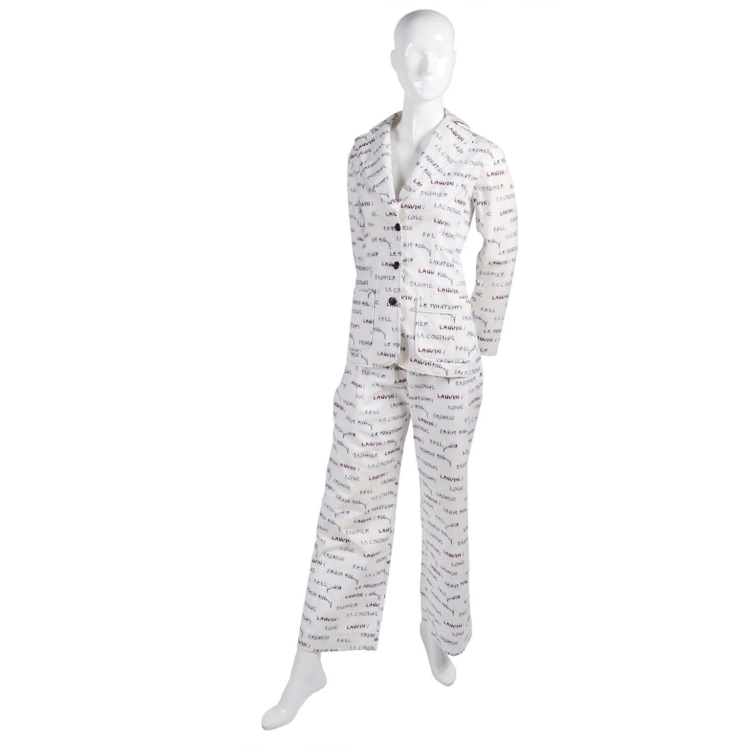 This rare vintage Lanvin white pantsuit is comprised of a jacket and a pair of pants in a monogram novelty print that is made of small people in red and blue, spelling out various words; Lanvin