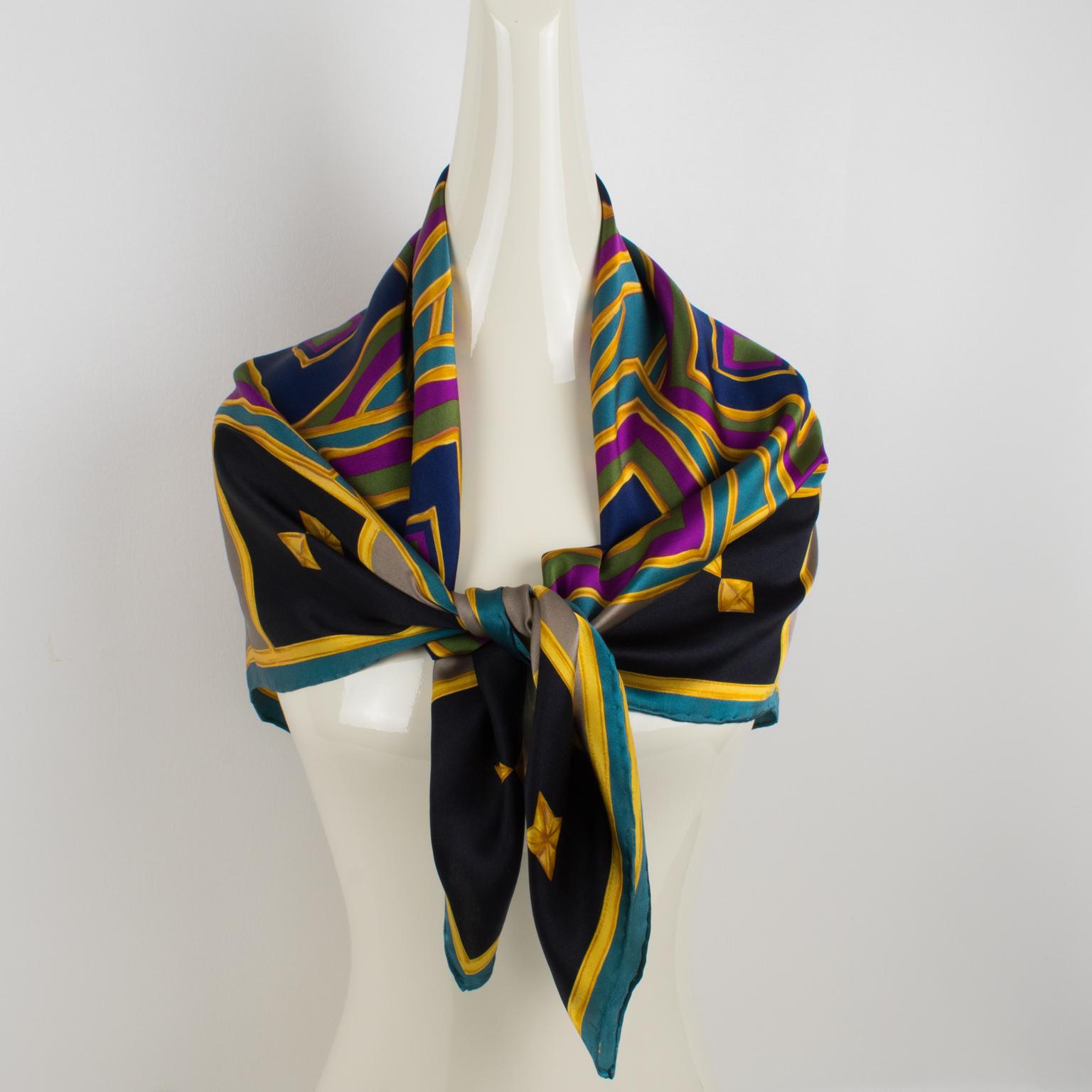 This elegant Lanvin Paris silk scarf in multicolor tones features an intricate geometric design print. This fashion accessory has the Lanvin Paris logo mark on the bottom right corner. The combination of navy blue, fuchsia pink, turquoise, black,