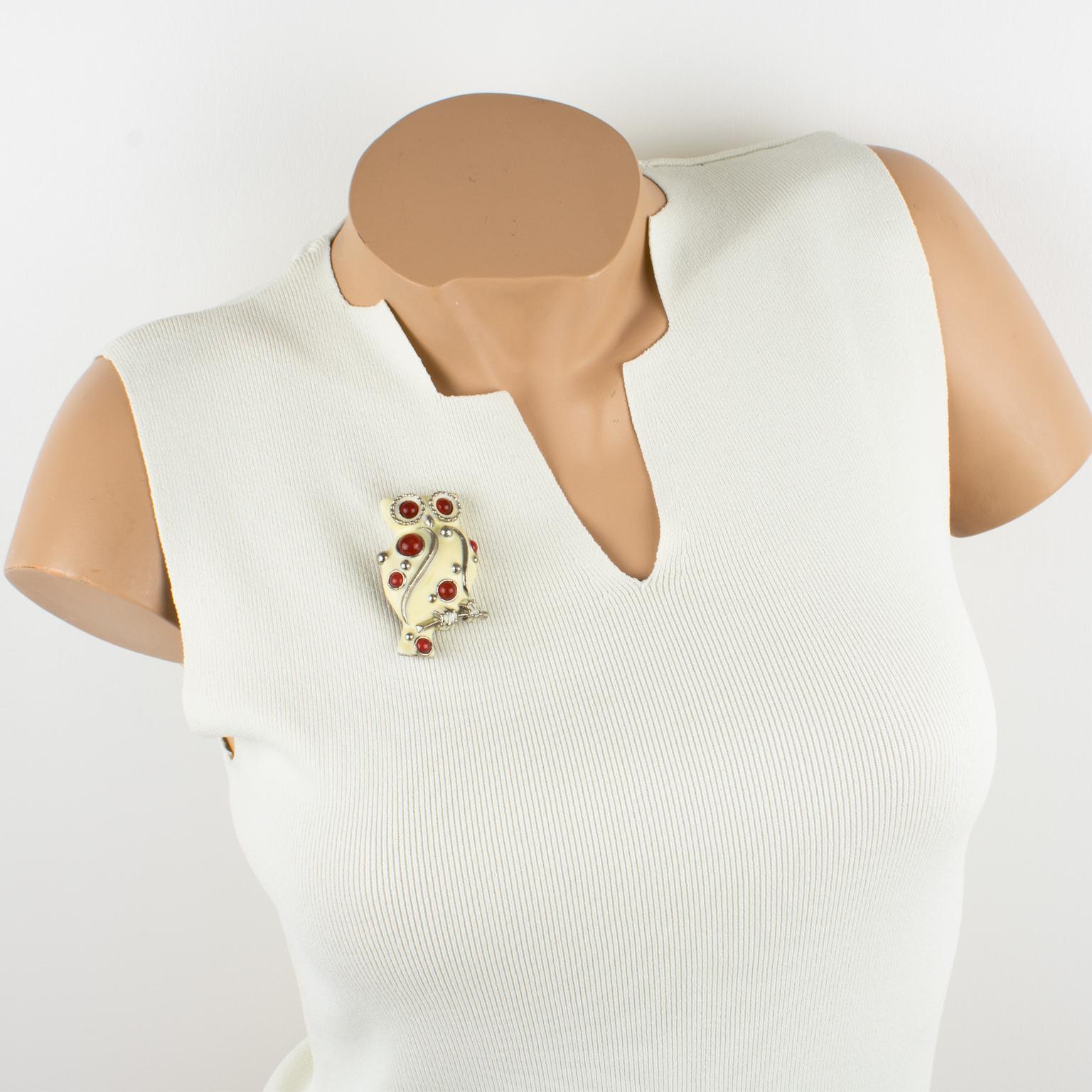 This lovely Lanvin Paris pin brooch features an owl with silvered metal framing topped with off-white enamel and complemented with Gripoix poured glass cabochons in carnelian color. The piece has a security closing clasp at the back and is signed