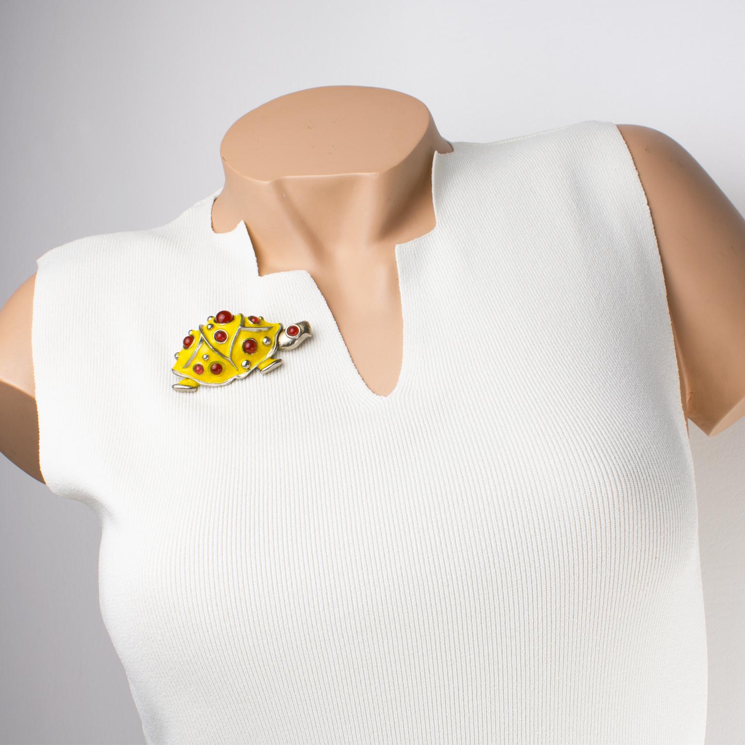 This rare Lanvin Paris brooch features a turtle with silvered metal framing, topped with yellow enamel and complemented by Gripoix poured glass cabochons in carnelian color. The piece has a security closing clasp at the back and is signed with a