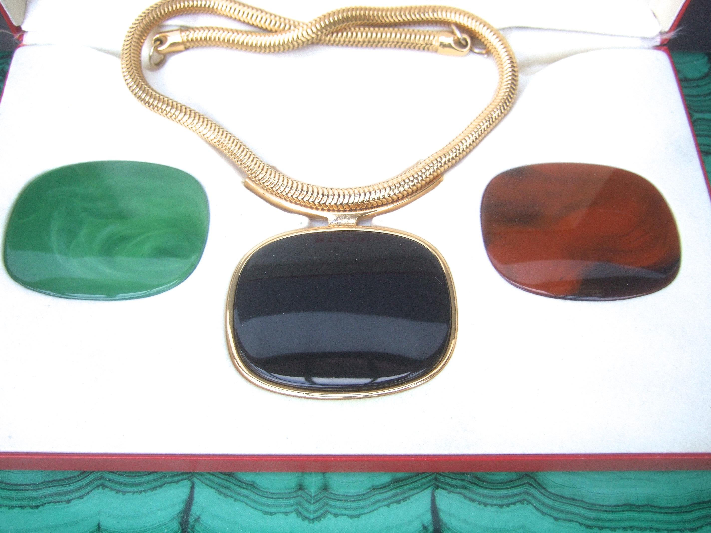 Lanvin Paris Sleek resin pendant choker necklace in Lanvin presentation box c 1970s
The iconic Lanvin choker necklace is designed with three molded resin large-scale interchangeable pendants. The trio of resin pendants range in color from jade