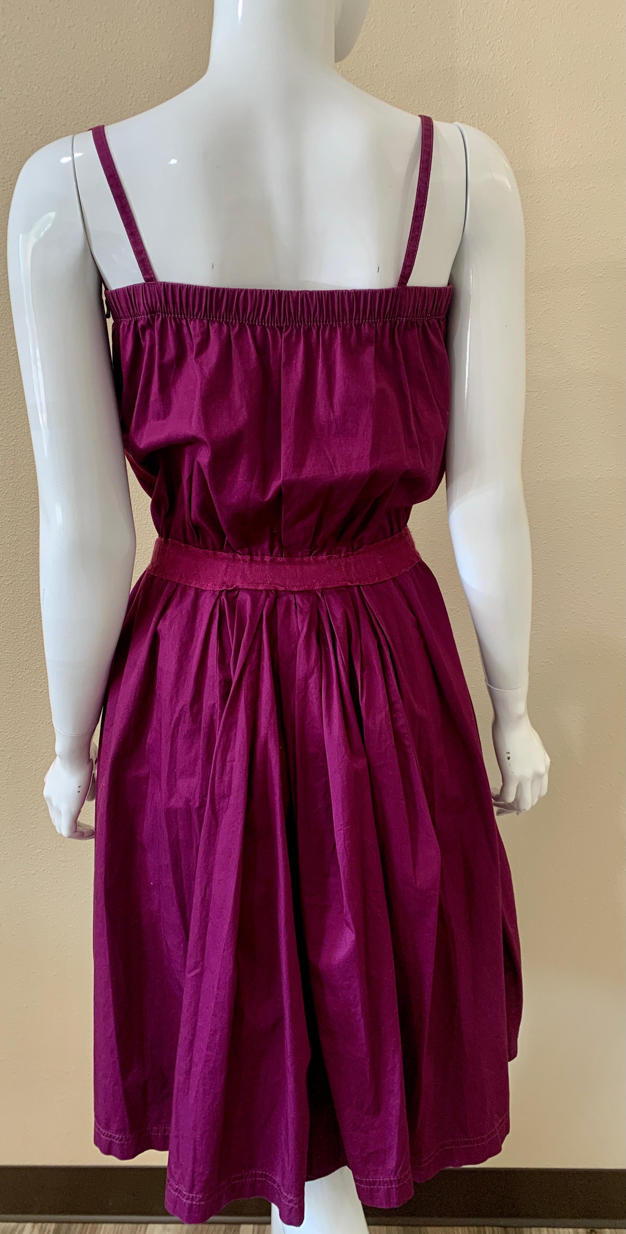 Cotton Purple Lanvin Day Dress that has a flower embellishment with a belt. Hits at the knee, vintage feel. Perfect for spring / summer days. Figure Flattering with gathering at the waist and chest. In good, but vintage condition. 

Size 42 but fits