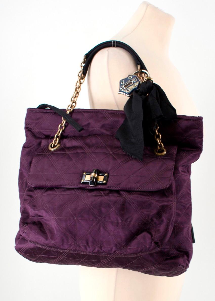 Lanvin Purple Satin Quilted HAPPY Tote Bag

- Purple in colour
- Satin fabric
- Quilted
- Black Lavin logo lining 
- Antique Gold hardware
- Flap compartment at the front with black toggle closure
- Hidden zip compartment at the back of the bag with