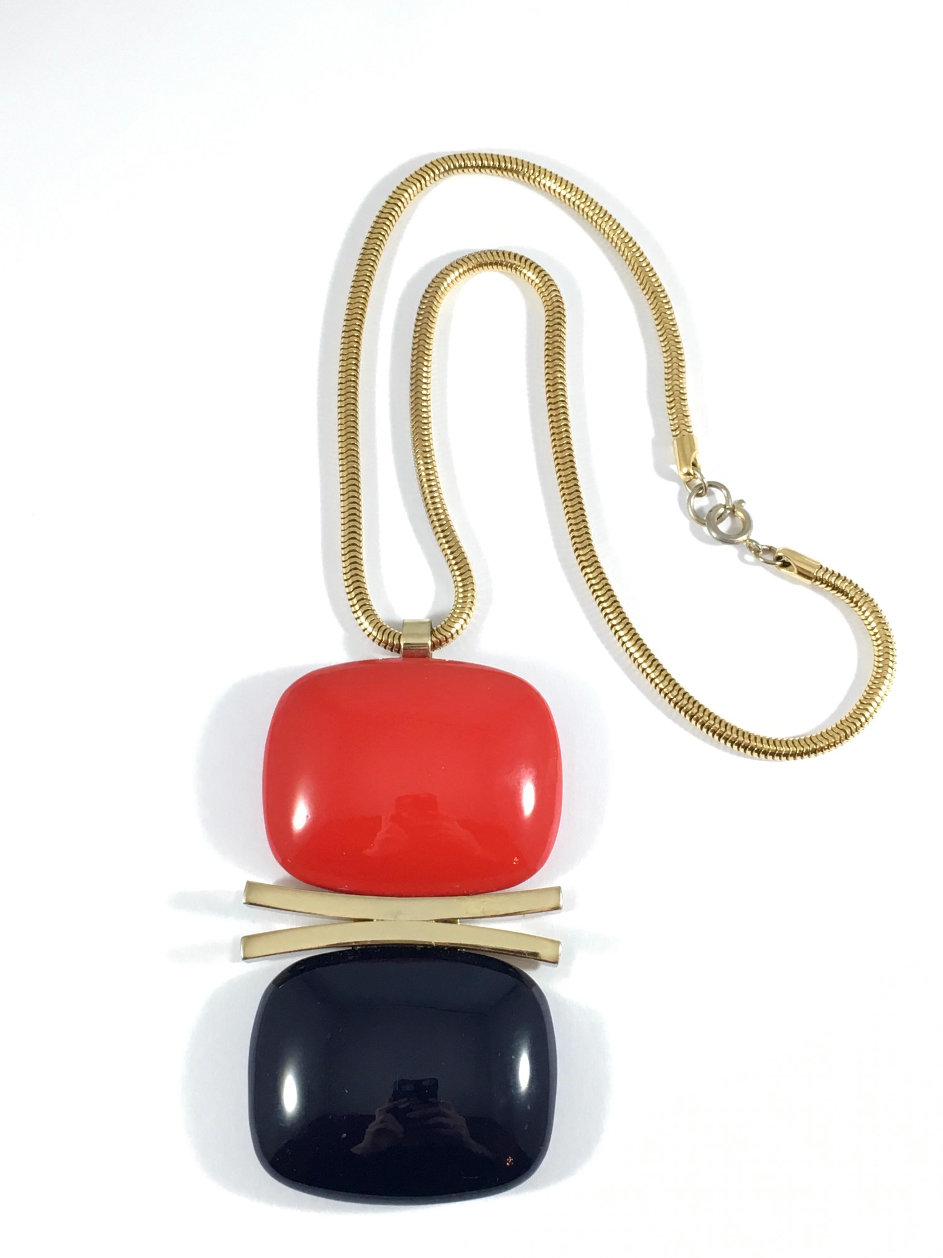 This is a fabulous red and navy Lanvin pendant necklace from the late 1960s/early 1970s. The large pendant is made out of a substantial resin and hangs from a goldtone 19 inch long snake chain. The pendant measures 4 1/2 inches long including the