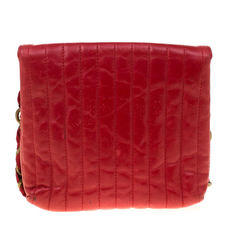 Luxuriously crafted this Lanvin bag is splendid to flaunt this season. Crafted from red quilted leather the bag can be carried using the gold-tone chain link that comes with a bow detail. Secured by a turn lock closure, the interior is lined with