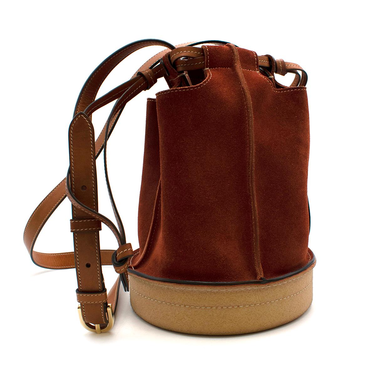 Lanvin Rust Suede Bucket Bag

Lanvin switches up the classic bucket bag style, introducing a more contemporary offering in the form of this drawstring bucket bag. Designed with a rust-orange calf suede exterior and a leather lining, this small-scale