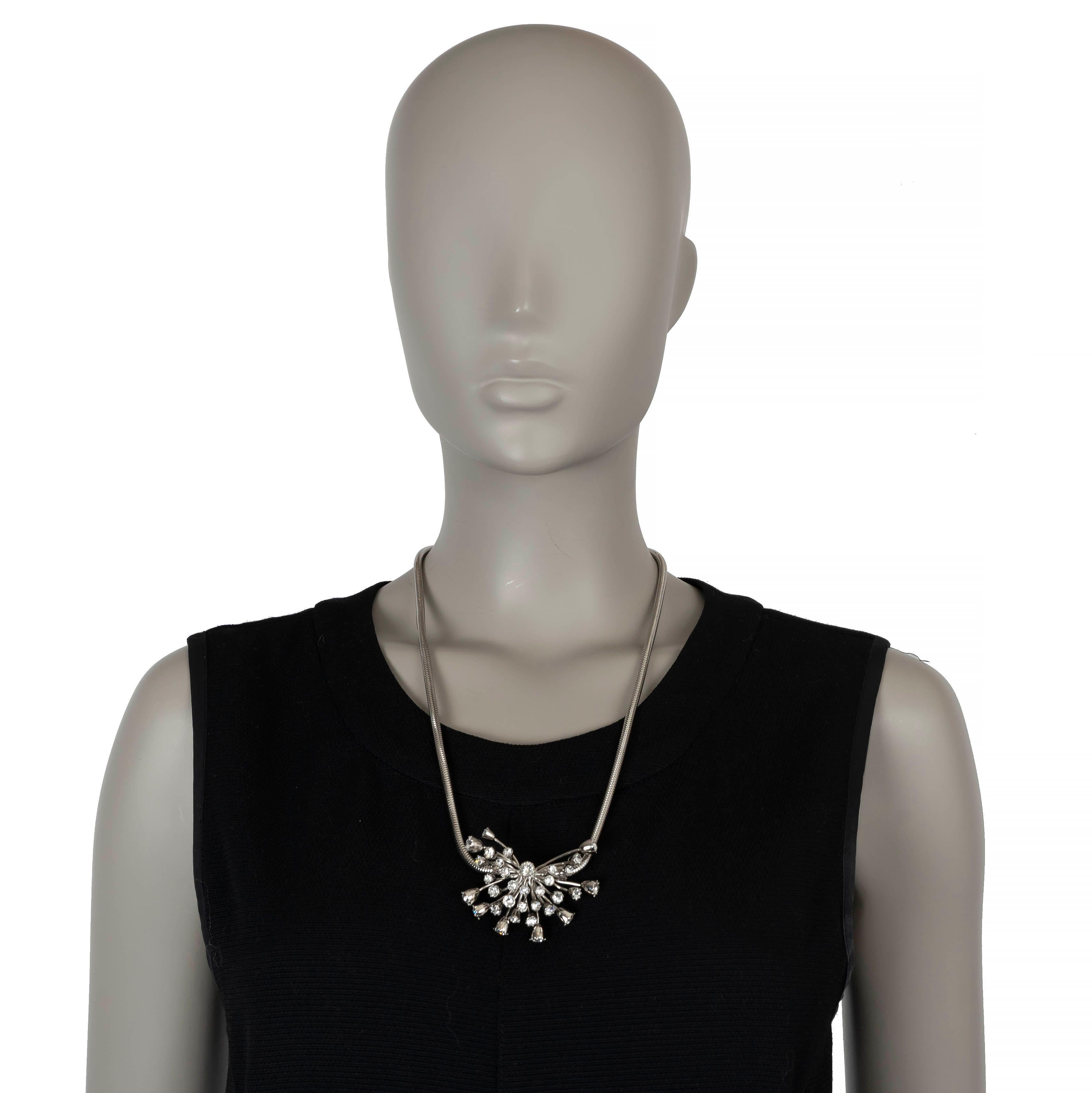 This 100% authentic Lanvin necklace features a silver-tone and black leather design, crafted from polished brass. It boasts a striking statement pendant adorned with crystal embellishments, and a self-tie fastening for an adjustable fit. A perfect