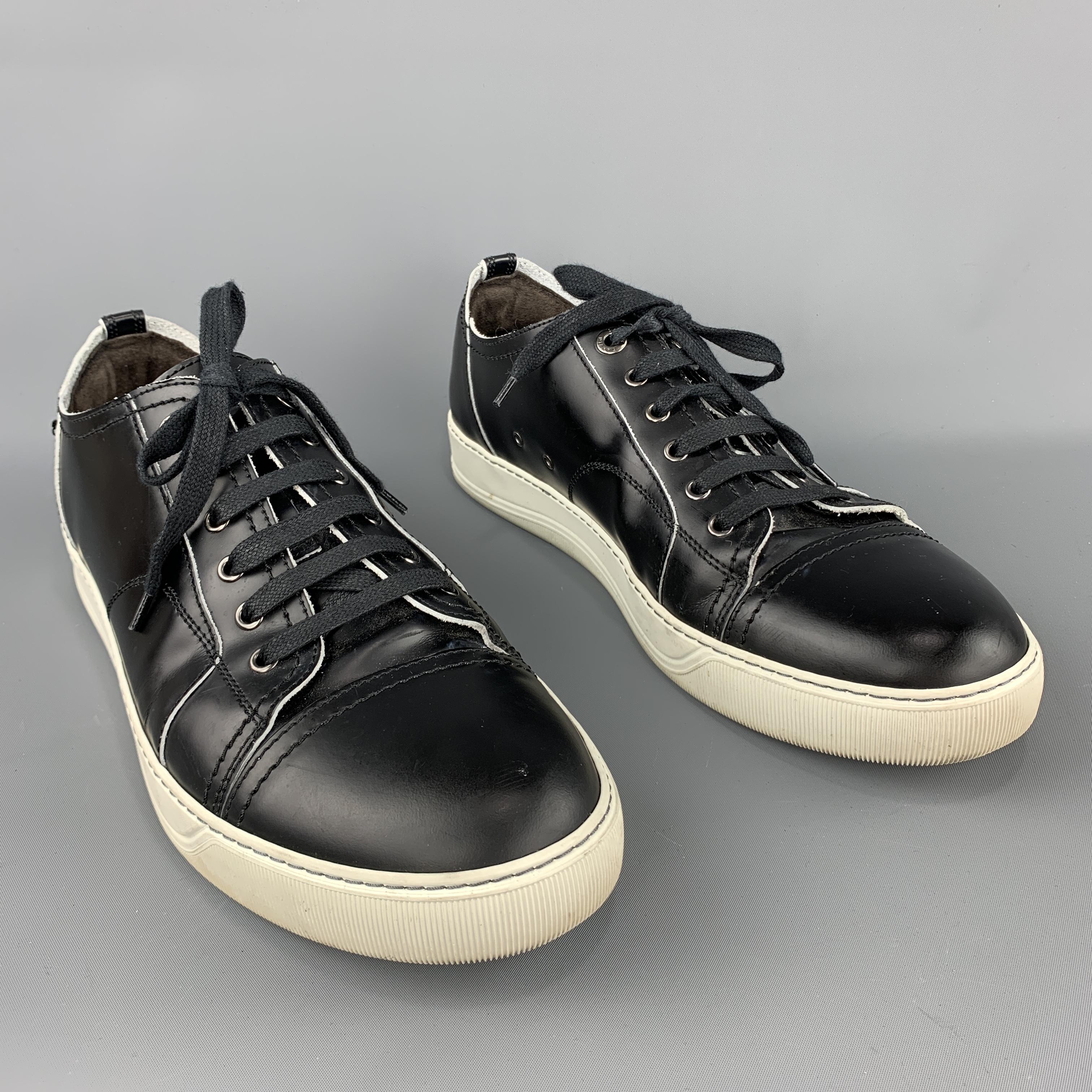 LANVIN Sneakers comes in a black tone in a solid smooth leather material, with a low top, a cap toe, a rubber sole, lace up. Made in Portugal.

Very Good Pre-Owned Condition.
Marked: 10

Outsole: 4.3 x 12.2 in. 