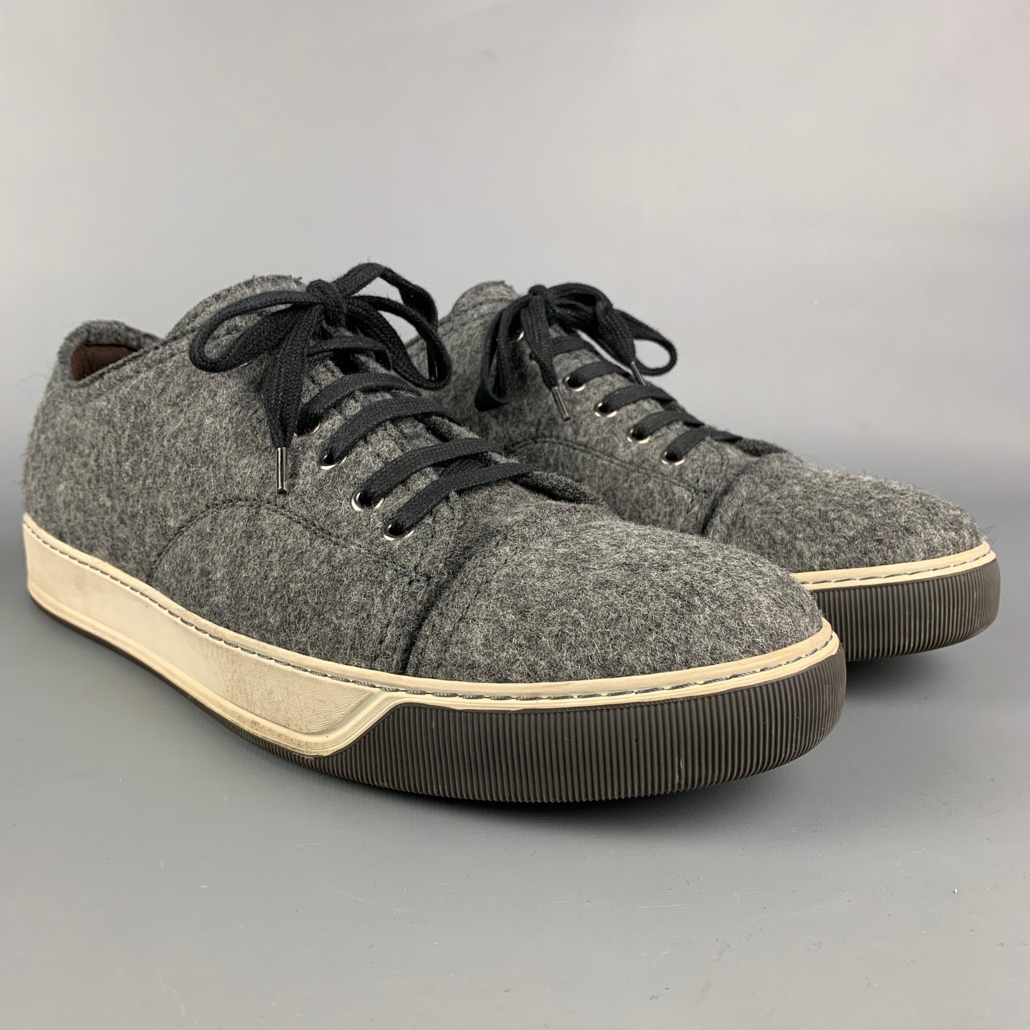 LANVIN sneakers comes in a dark gray textured fabric featuring a cap toe, rubber sole, and a lace up closure. Made in Portugal. 

Very Good Pre-Owned Condition.
Marked: 10

Outsole: 12.5 in. x 4.5 in. 