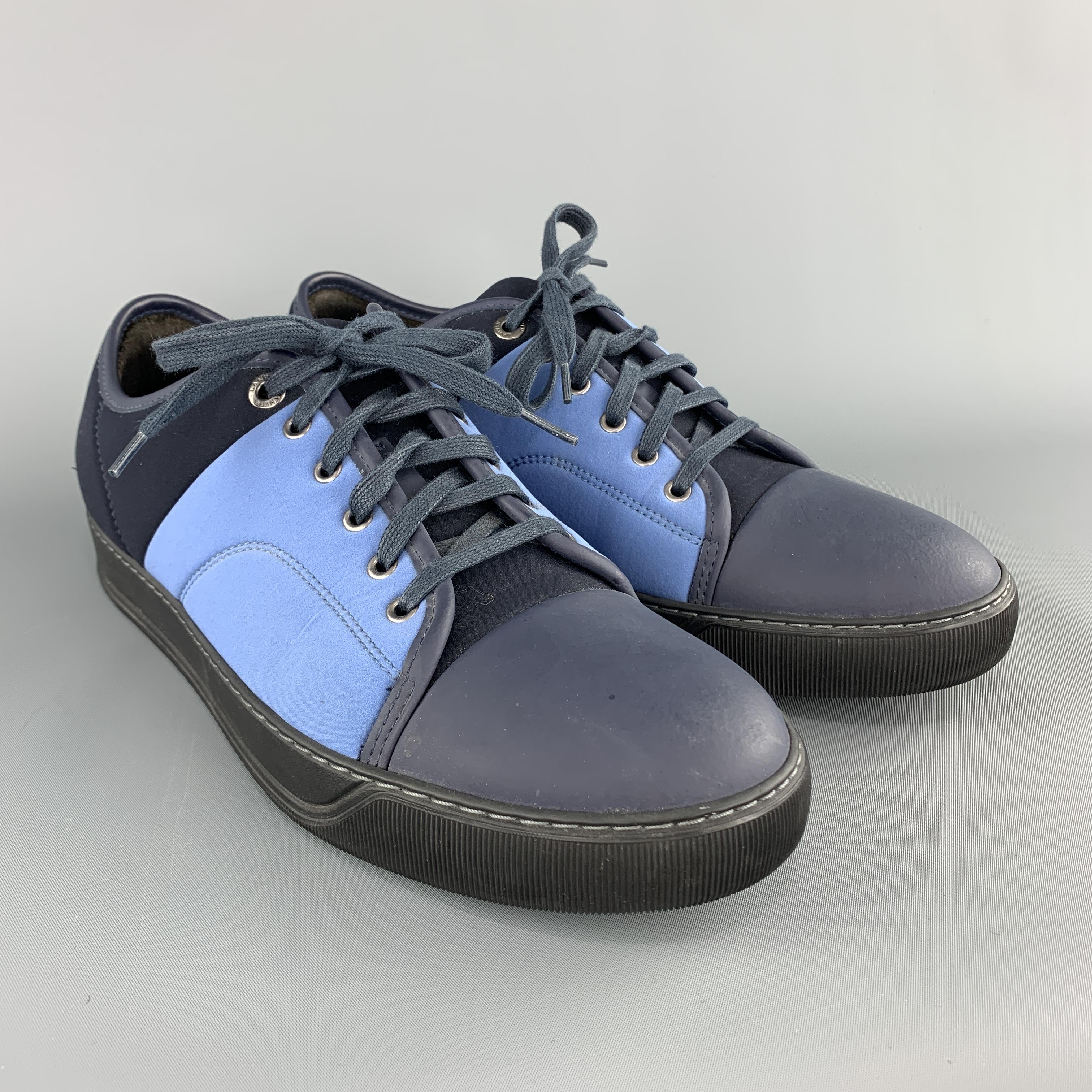 LANVIN low top sneakers come in navy neoprene with a rubber cap toe, lace up front, and blue side panels. Made in Portugal.

Very Good Pre-Owned Condition.
Marked: UK 9

Outsole: 12 x 4.5 in.