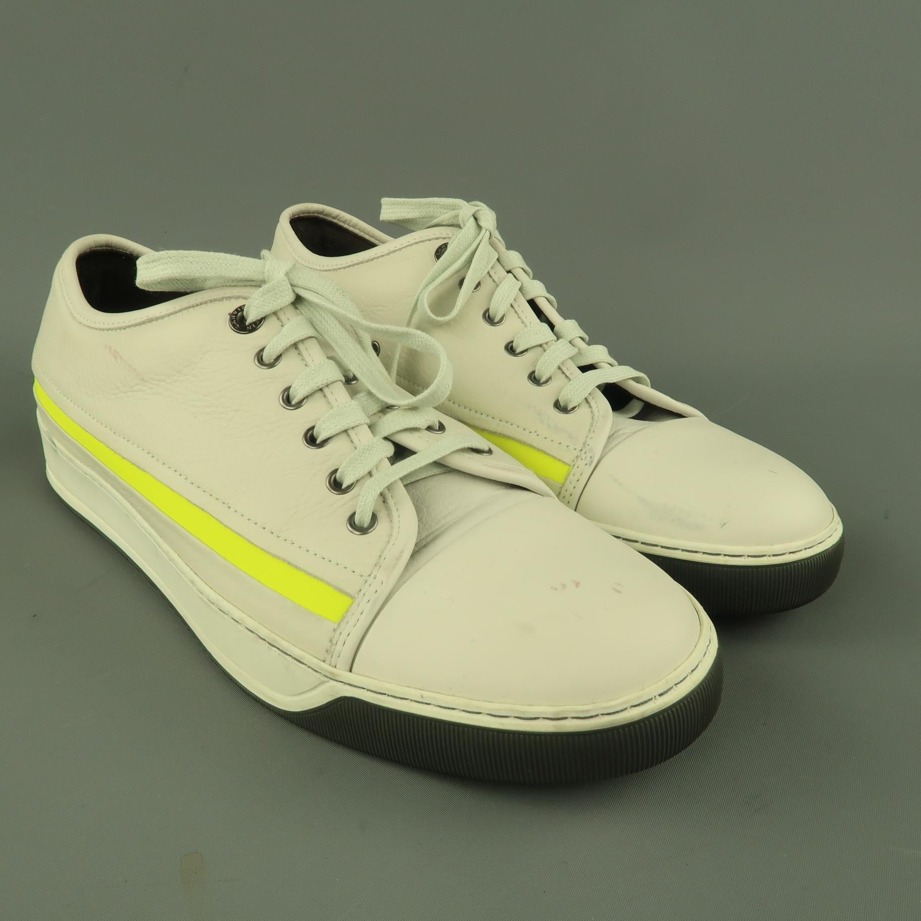 LANVIN low top sneakers com in a gray toned off white textured leather with a cap toe, dual tone rubber sole, and neon stripe detail. Wear throughout. As-is. Made in Portugal.
 
Good Pre-Owned Condition.
Marked: UK 9
 
Outsole: 12 x 4.25 in.