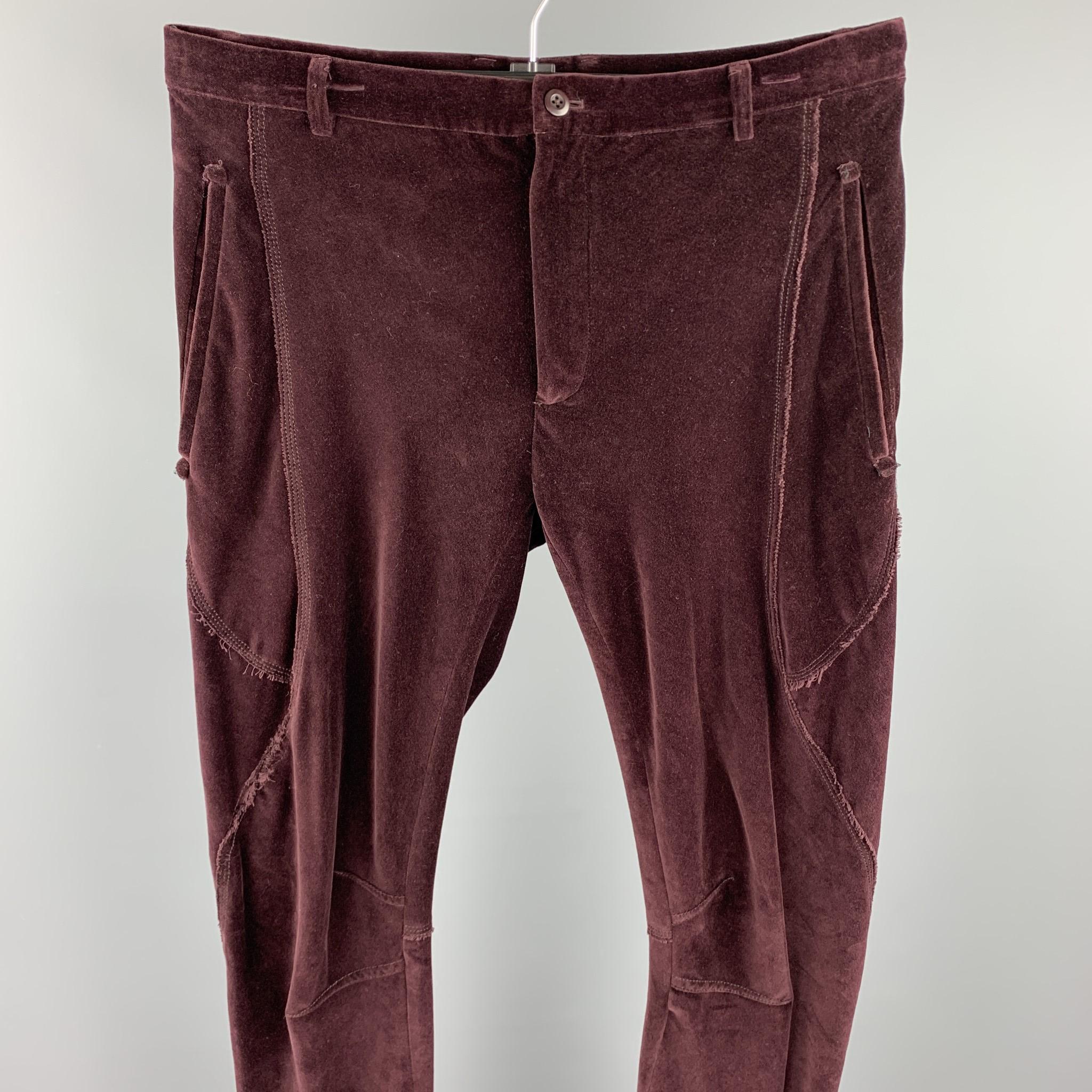 LANVIN casual pants comes in a burgundy cotton velvet featuring a slim fit, stitching details, zipper pockets, and a zip fly closure.

Very Good Pre-Owned Condition.
Marked: 48

Measurements:

Waist: 34 in. 
Rise: 9 in. 
Inseam: 31 in. 