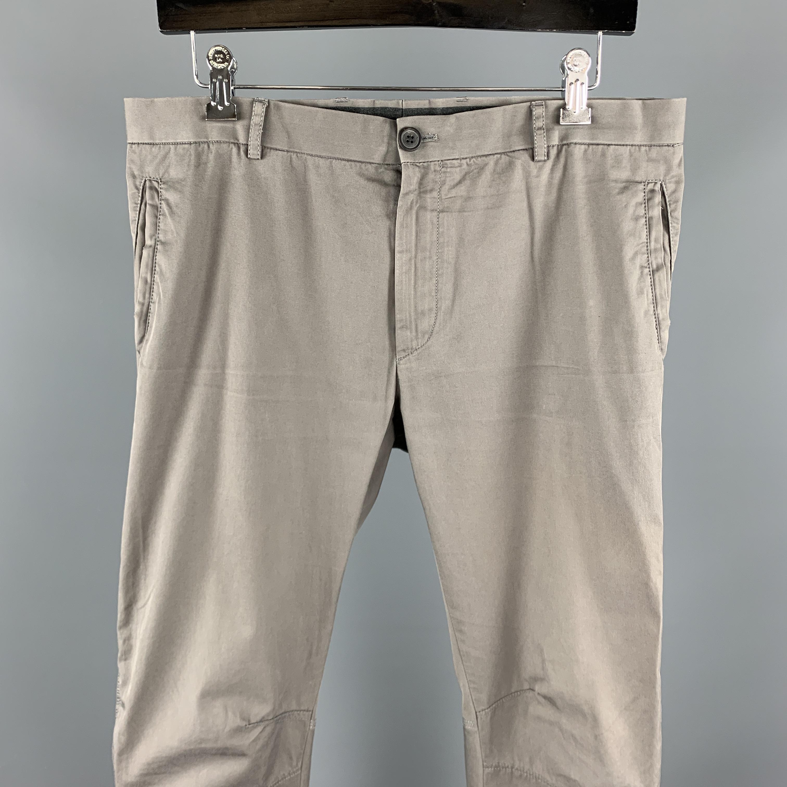 LANVIN casual pants comes in a gray cotton blend featuring a skinny fit, knee stitching, leg zipper details, and a zip fly closure. Made in Romania.

Excellent Pre-Owned Condition.
Marked: 48

Measurements:

Waist: 34 in.
Rise: 8.5 in.
Inseam: 29 in.