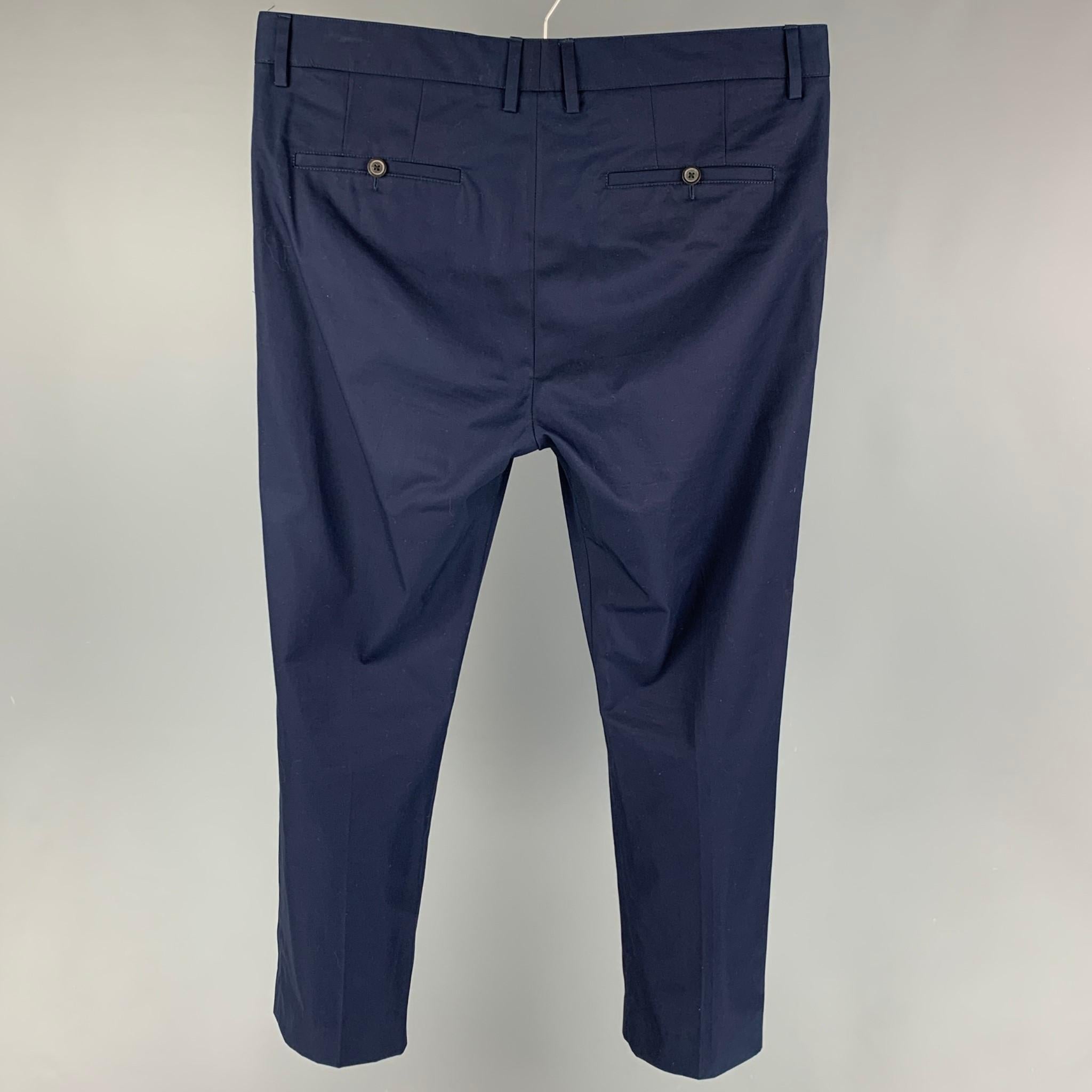 LANVIN casual pants comes in a navy cotton featuring a slim fit, drawstring, and a zip fly closure. 

Very Good Pre-Owned Condition.
Marked: 48

Measurements:

Waist: 36 in.
Rise: 12.5 in.
Inseam: 26 in. 