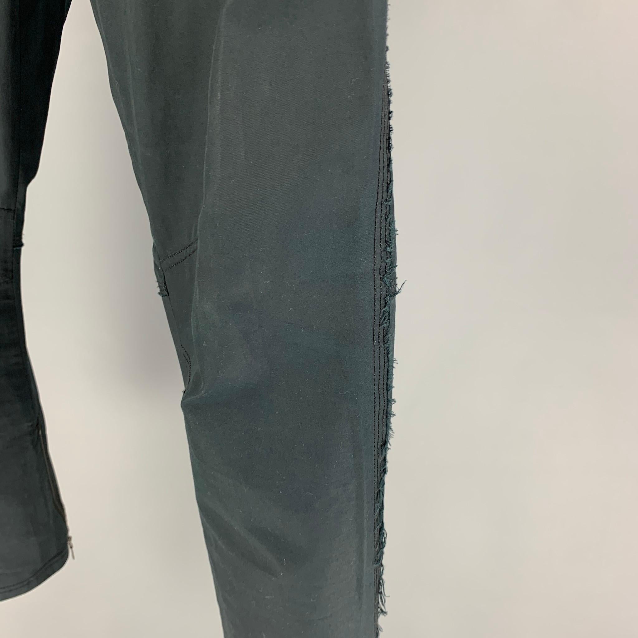LANVIN pants comes in a navy cotton featuring a slim fit, zipped cuffs, raw edge trim, and a zip fly closure. 

Good Pre-Owned Condition.
Marked: 50

Measurements:

Waist: 34 in.
Rise: 10 in.
Inseam: 29 in. 