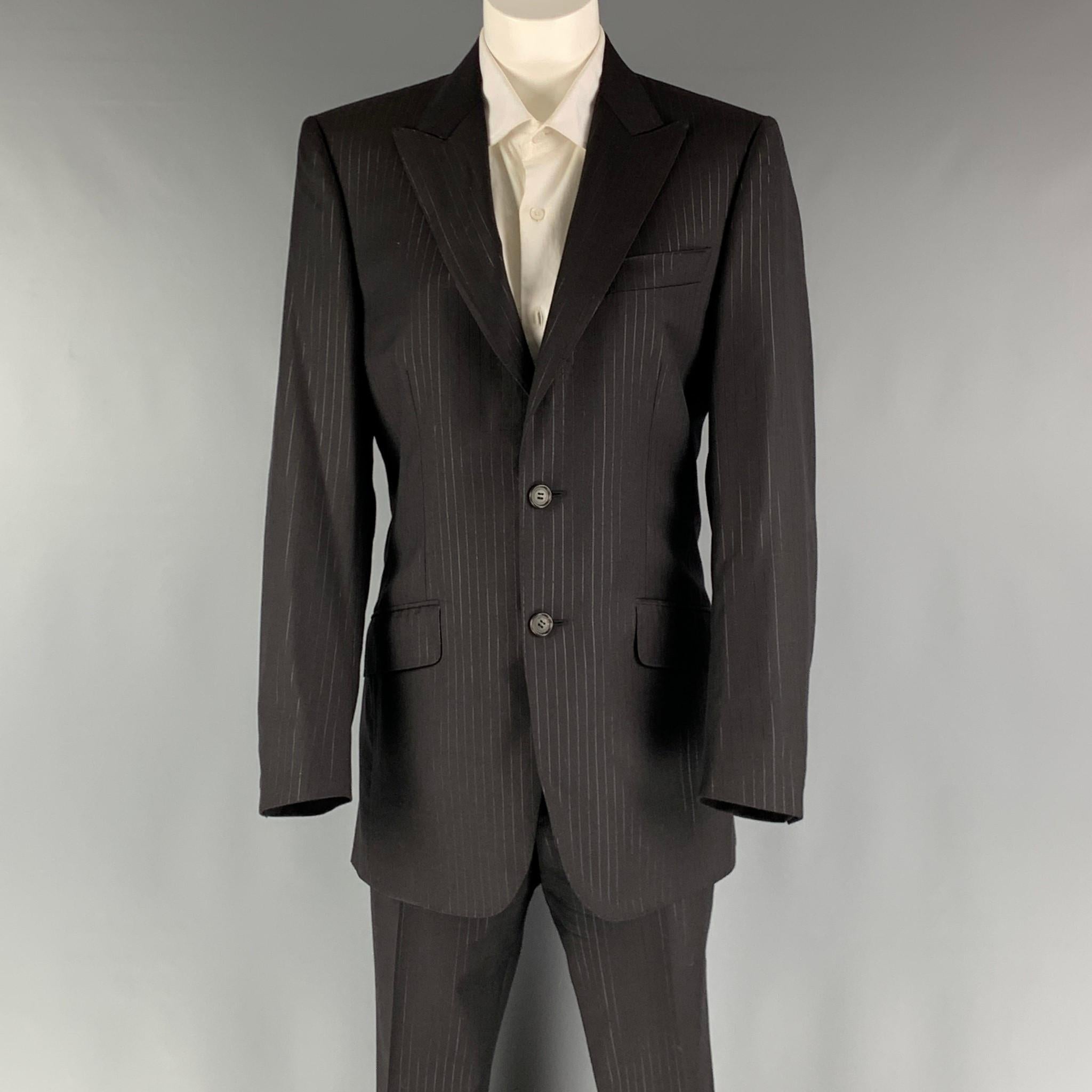 LANVIN suit comes in a black striped wool woven material with no lining and includes a single breasted, double button sport coat with a peak lapel and matching pleated front trousers. Made in Italy.

Excellent Pre-Owned Condition.
Marked: