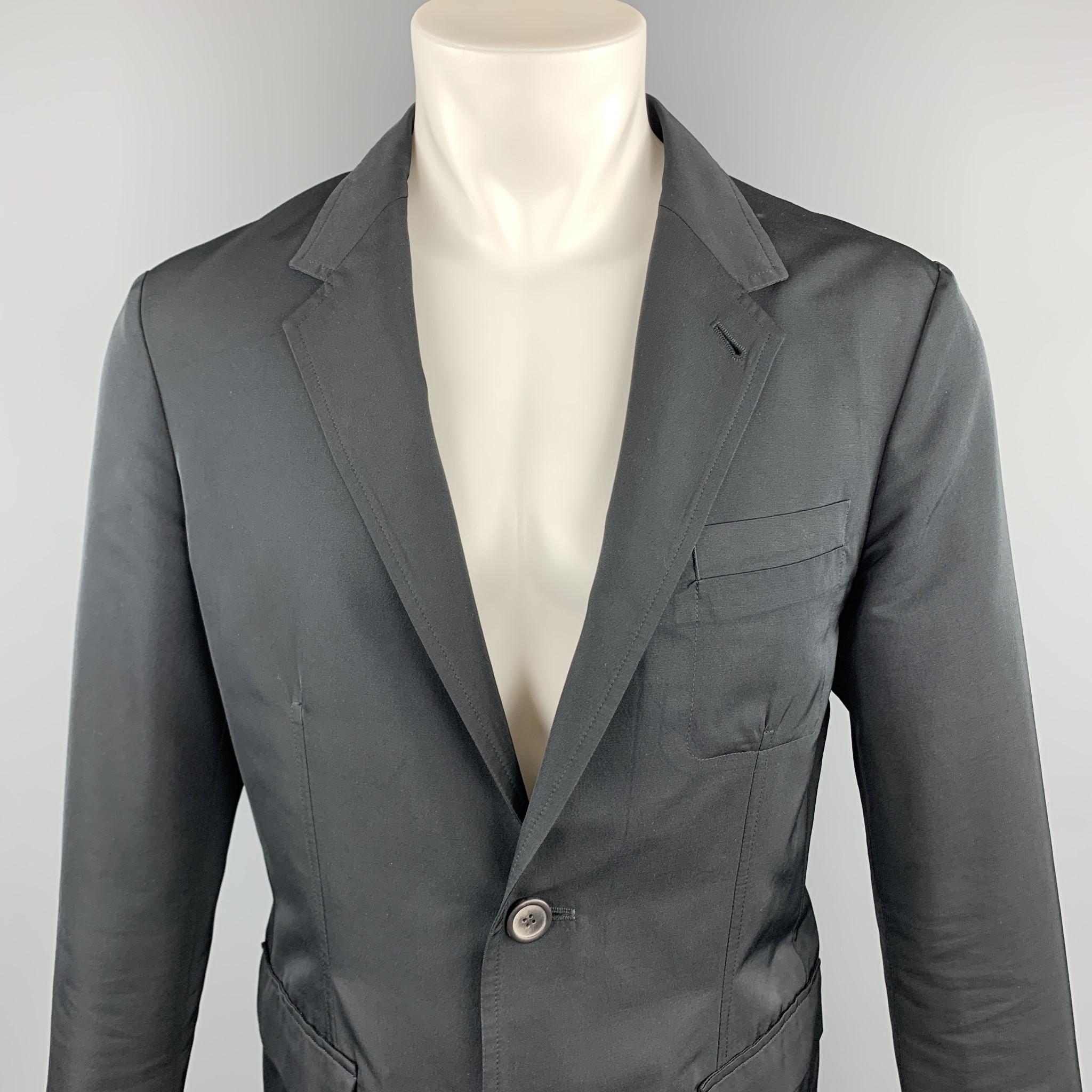 LANVIN sport coat comes in a black polyester / wool featuring a notch lapel style, patch pockets, and a two button closure. Made in Romania.

Excellent Pre-Owned Condition.
Marked: 48

Measurements:

Shoulder: 17 in. 
Chest: 38 in. 
Sleeve: 26 in.