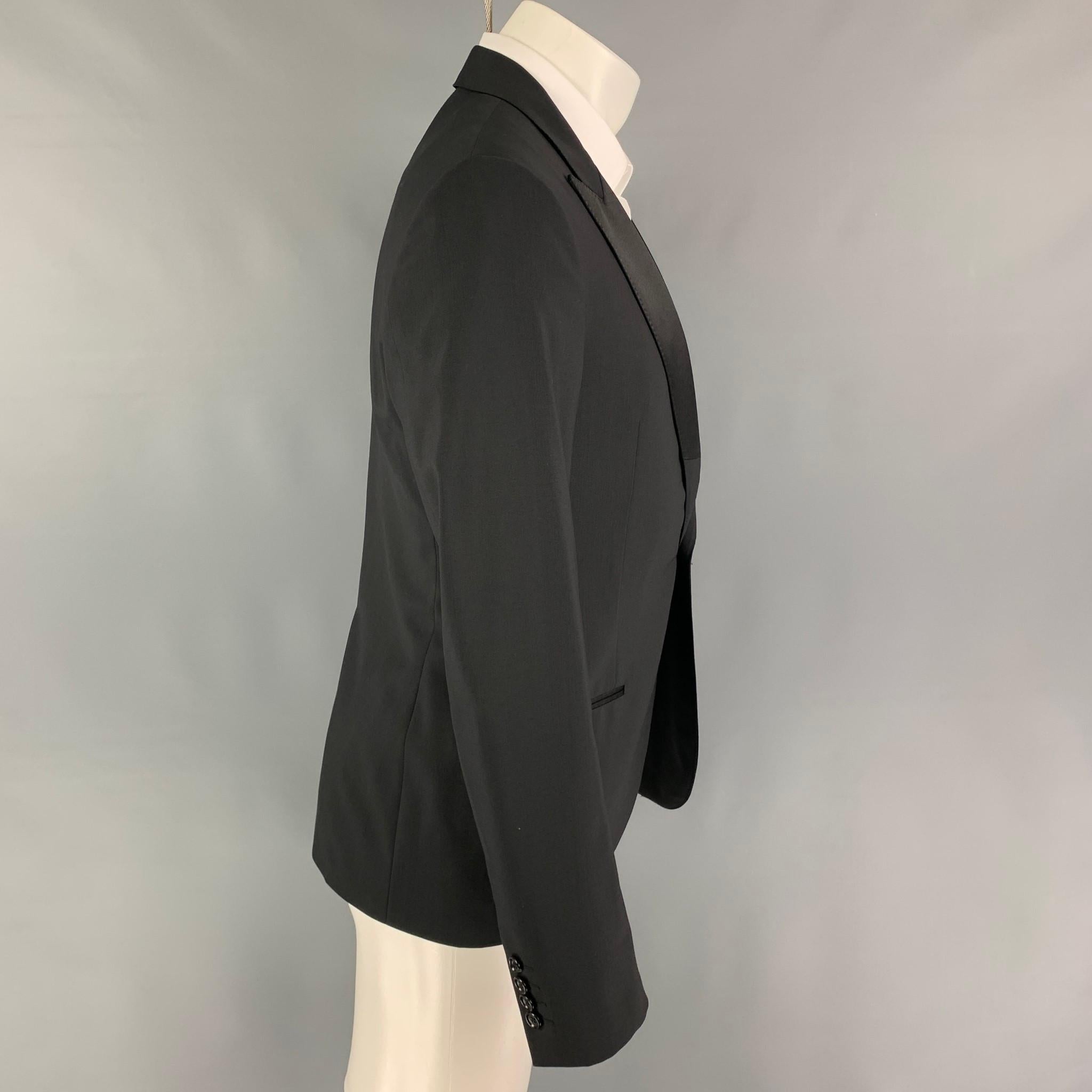 LANVIN sport coat comes in a black wool / lycra with a full liner featuring a peak lapel, slit pockets, single back vent, and a single button closure. 

Excellent Pre-Owned Condition.
Marked: 48 R

Measurements:

Shoulder: 17.5 in.
Chest: 38