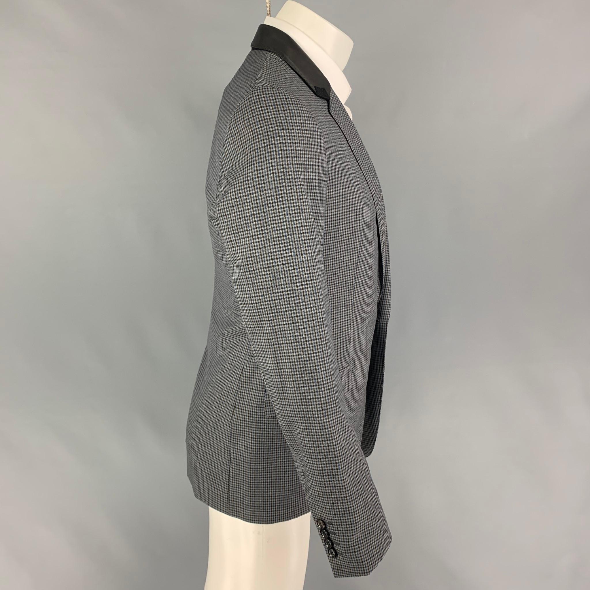 LANVIN sport coat comes in a grey, black, blue plaid wool with a full liner featuring a notch lapel, leather trim, flap pockets, single back vent, and a single button closure. Made in Italy. 

Very Good Pre-Owned Condition.
Marked: