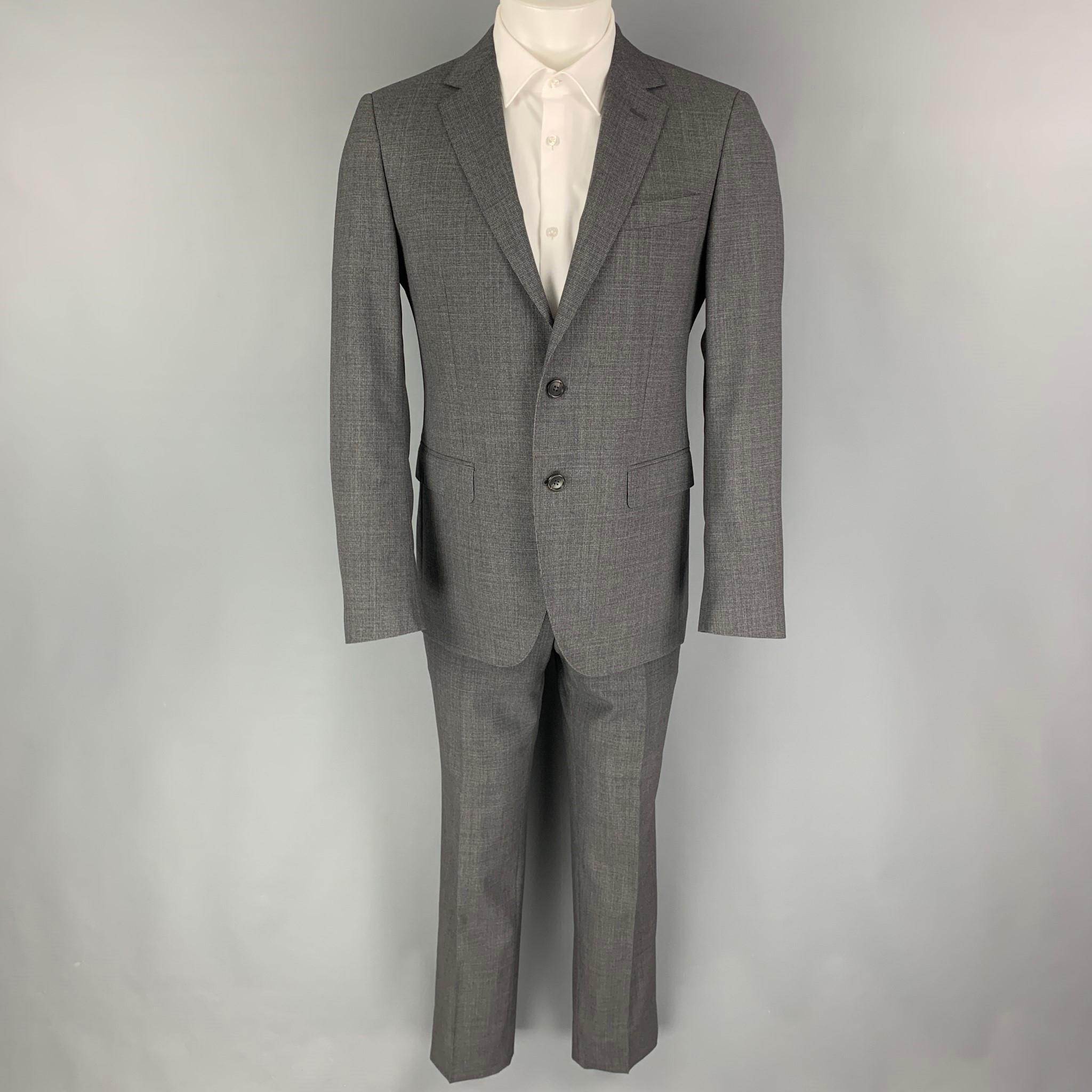 LANVIN suit comes in a grey grid wool with a full liner and includes a single breasted, double button sport coat with a notch lapel and matching flat front trousers.

Excellent Pre-Owned Condition.
Marked: 48

Measurements:

-Jacket
Shoulder: 17