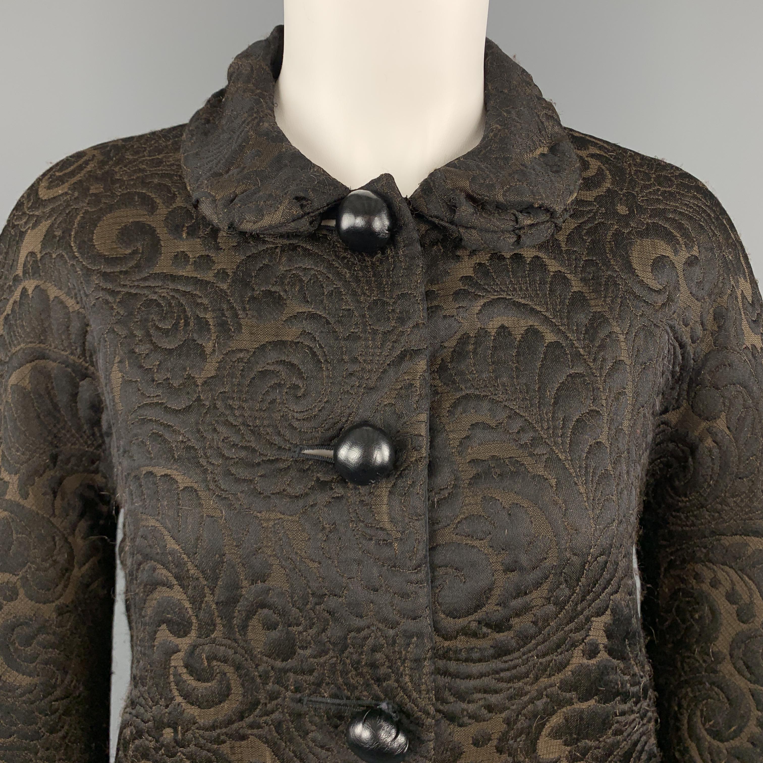 LANVIN Fall 2006 cropped jacket comes in brown and black textured brocade fabric with a Peter Pan collar and stuffed black leather buttons. Wear throughout fabric. Made in France.

Good Pre-Owned Condition.
Marked: FR 36

Measurements:

Shoulder: 16