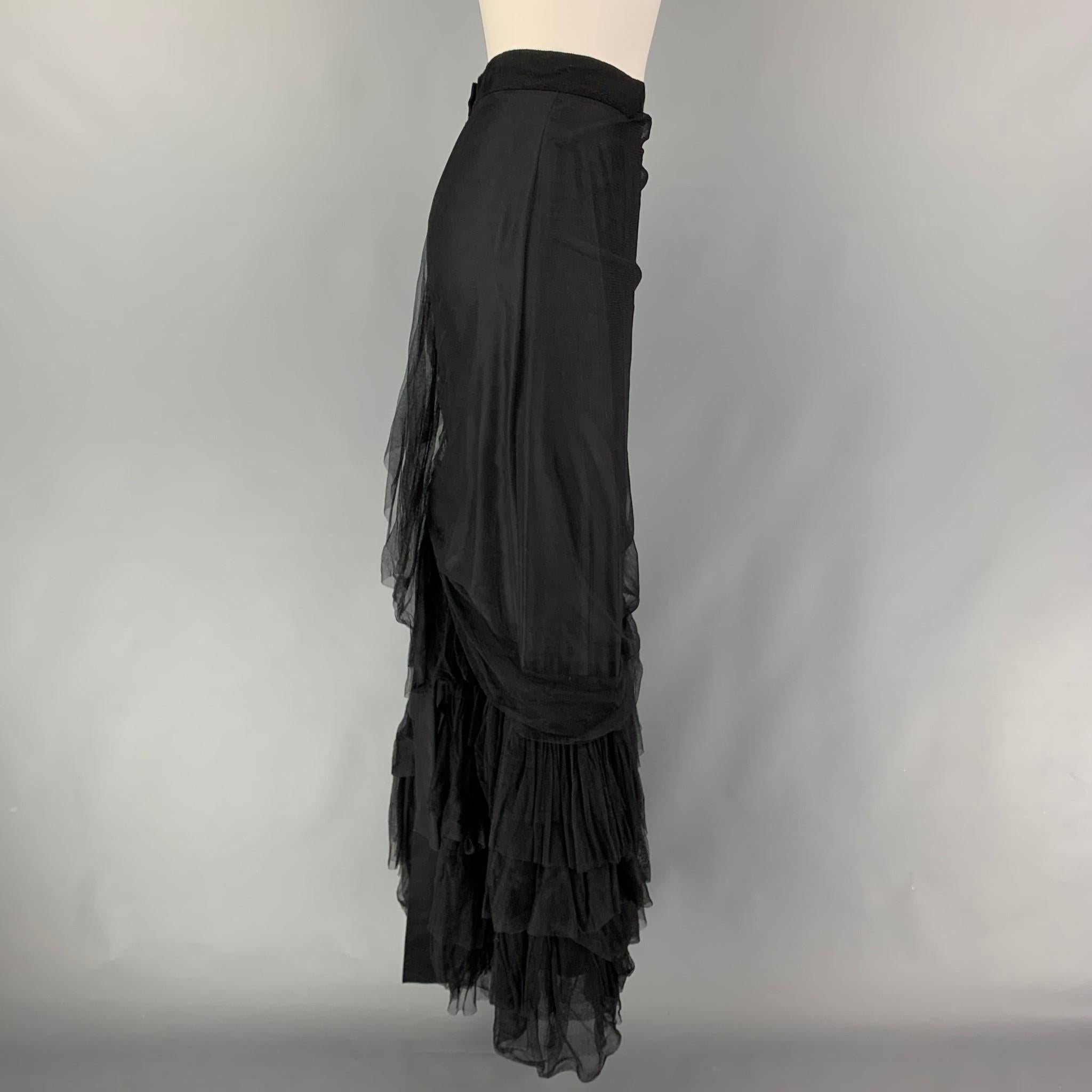 LANVIN 2009 skirt comes in a mesh black silk blend featuring a ruffled design, ribbon trim, and a back zip up closure. Made in France. 

Very Good Pre-Owned Condition.
Marked: 38

Measurements:

Waist: 28 in.
Hip: 32 in.
Length: 42 in.