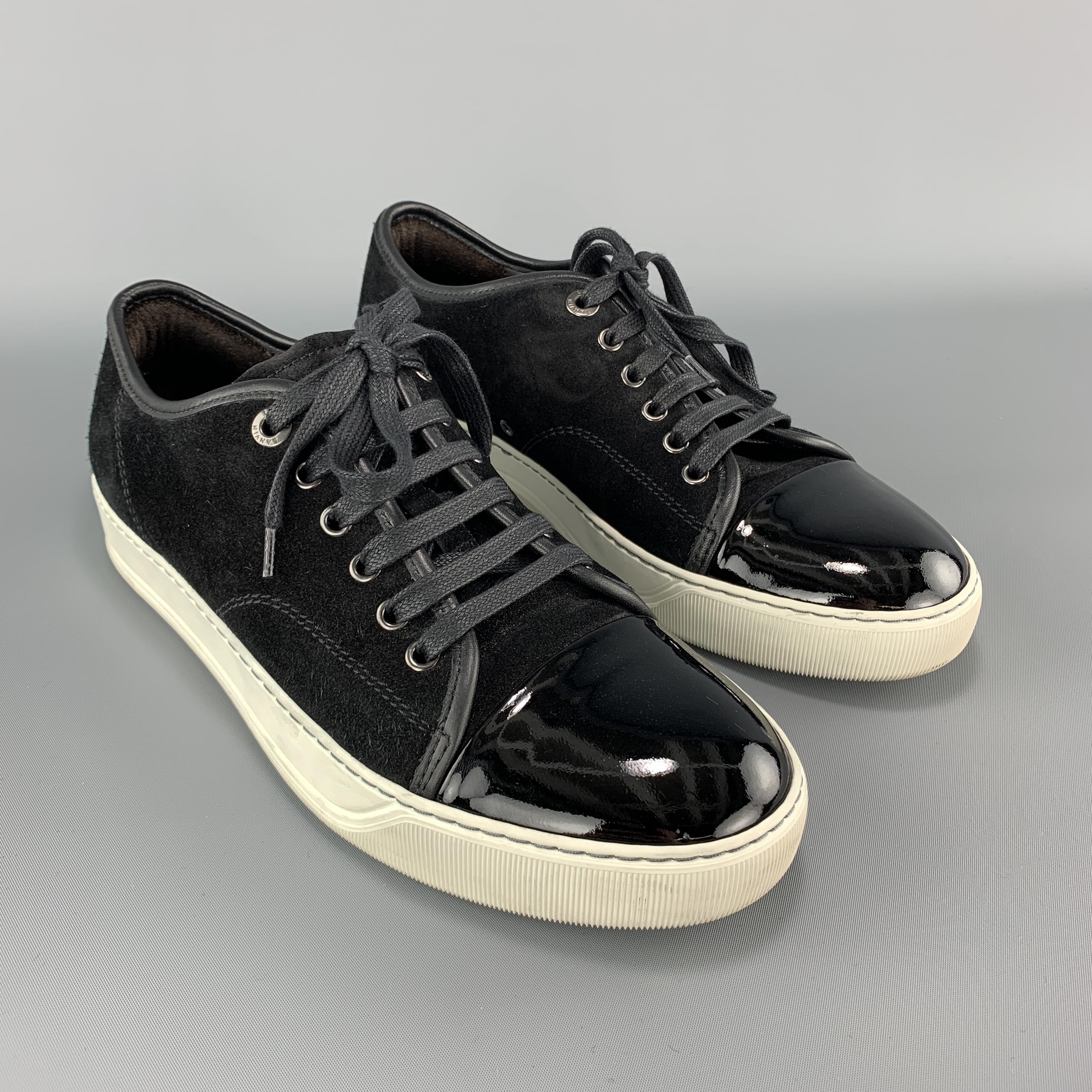 LANVIN sneakers come in black suede with a patent leather toe cap and white rubber sole. Made in Portugal.

Very Good Pre-Owned Condition.
Marked: UK 5

Outsole: 11 x 4 in.