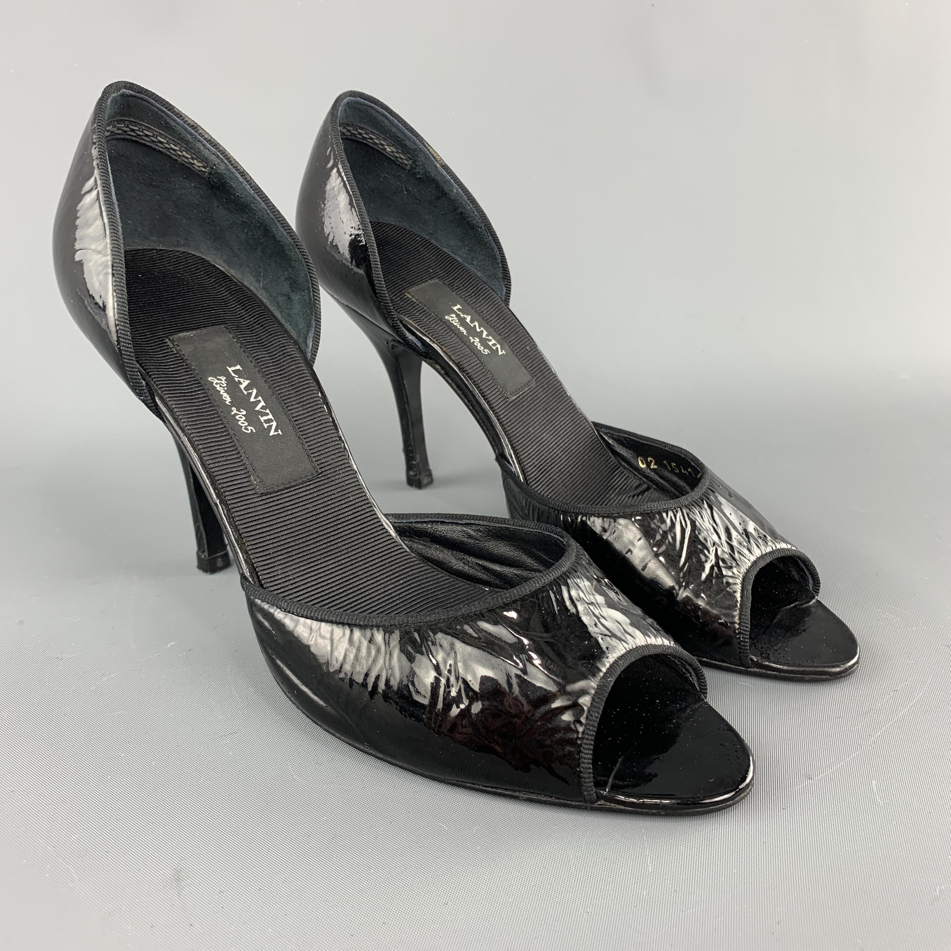 LANVIN D'orsay pumps come in black patent leather with ribbon piping and a peep toe. Made in Italy.

Good Pre-Owned Condition.
Marked: IT 37

Measurements:

Heel: 3.75 in.