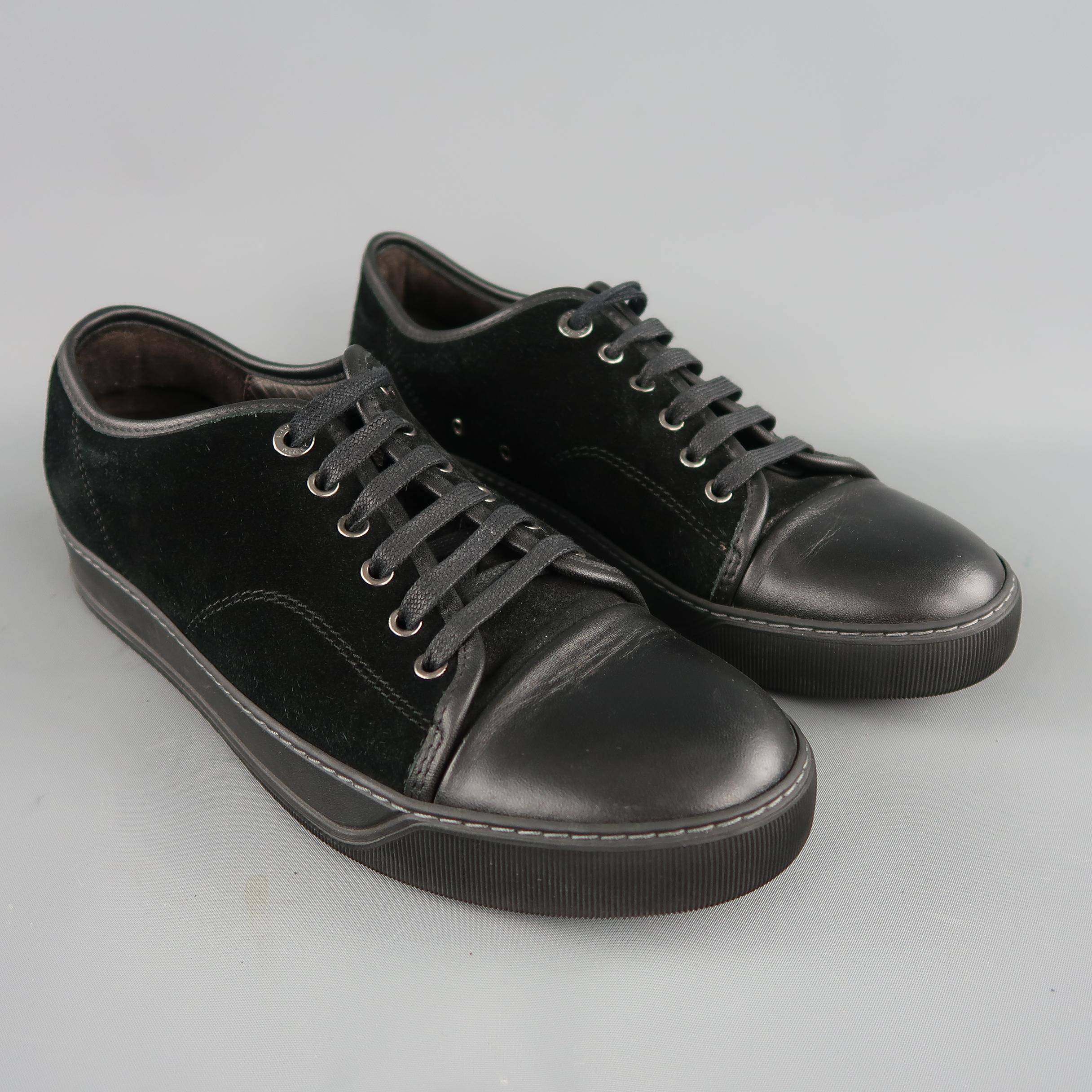 LANVIN low top sneakers come in black suede with a leather toe cap and piping, and tonal rubber sole. Made in Portugal.
 
Very Good  Pre-Owned Condition.
Marked: UK 7
 
Measurements:
 
Length: 11.5 in.
Width: 4.5 in.