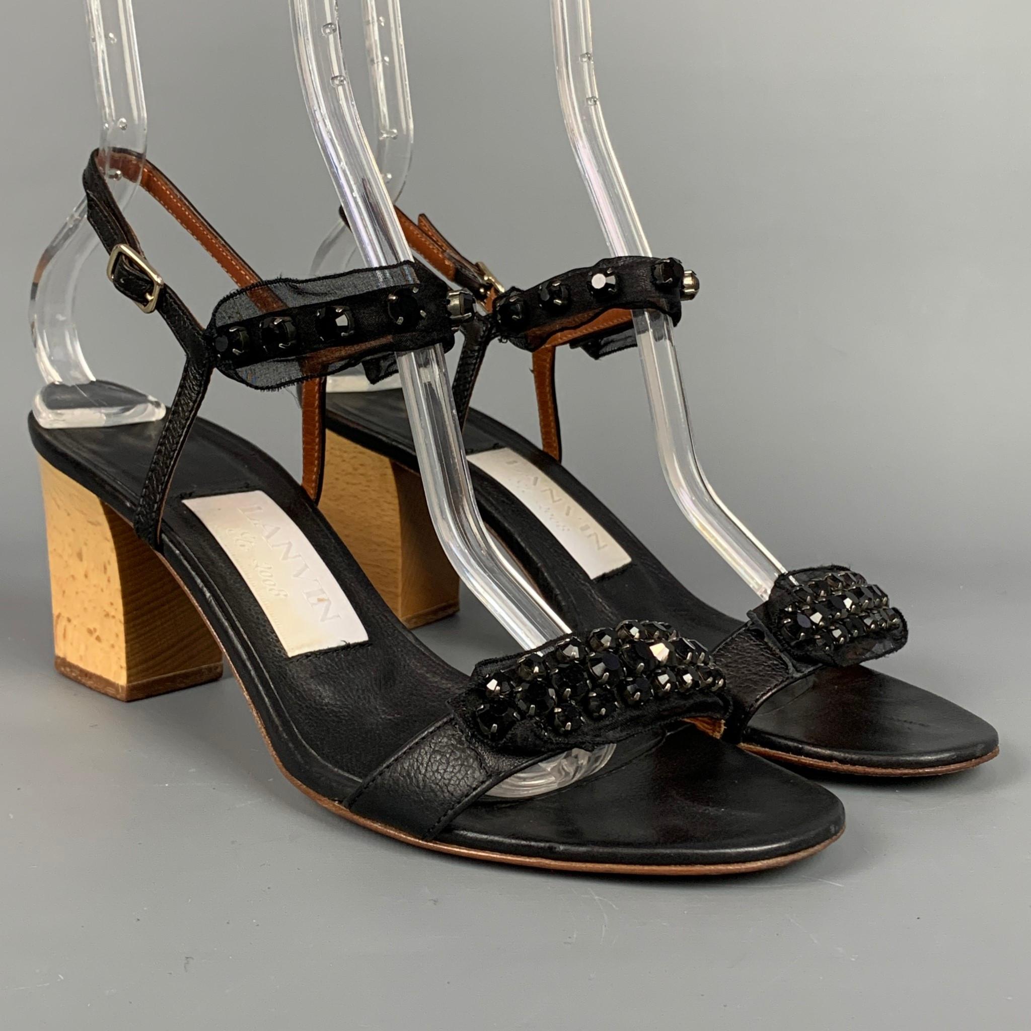 LANVIN sandals comes in a black leather with a silk ribbon featuring rhinestone details, ankle strap, and a stacked heel. Made in Italy.

Very Good Pre-Owned Condition.
Marked: IT 39

Measurements:

Heel: 3 in.