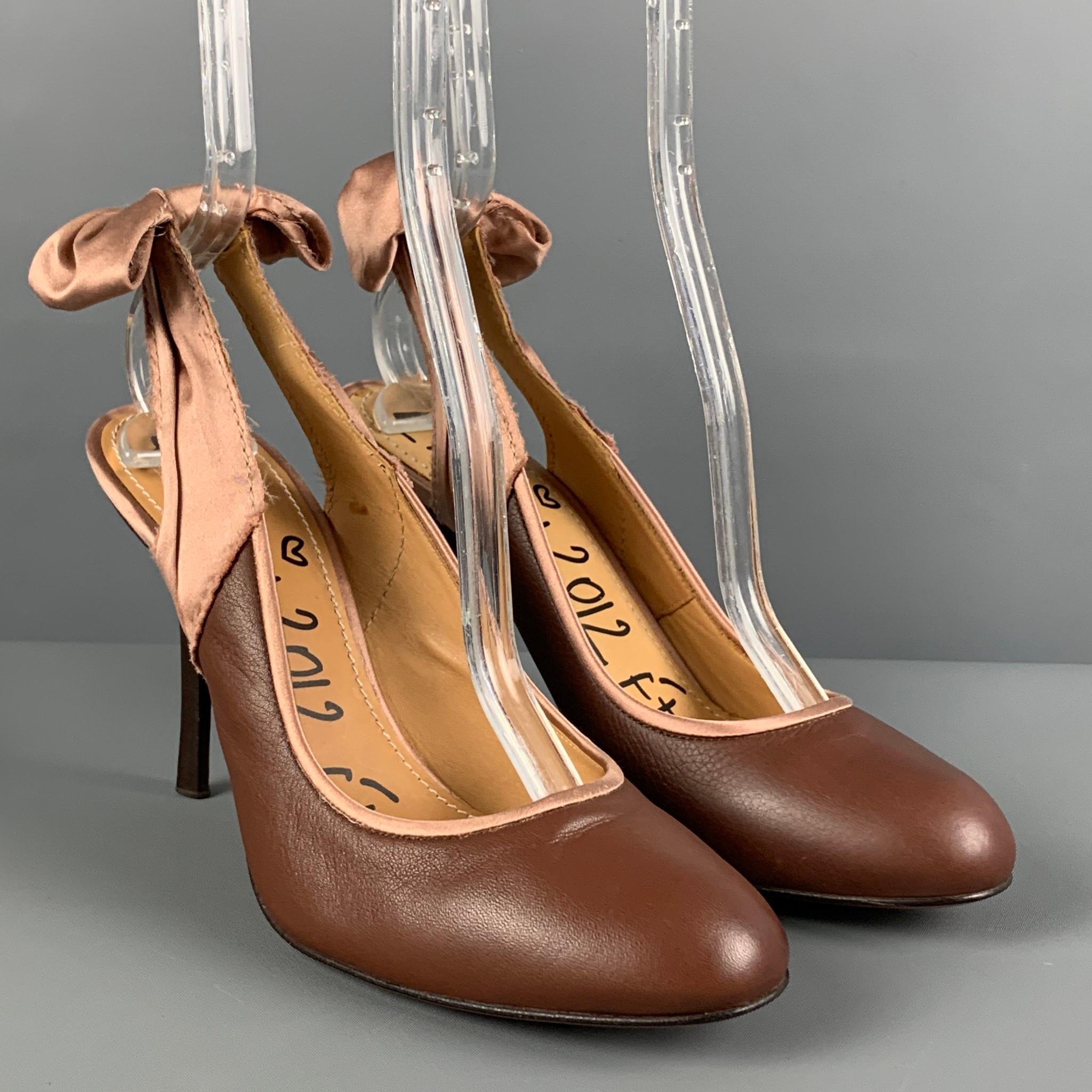 LANVIN pumps comes in a brown leather with a pink satin trim featuring a slingback style, bow detail, and a stiletto heel. 

Very Good Pre-Owned Condition.
Marked: 39

Measurements:

Heel: 3.75 in. 
