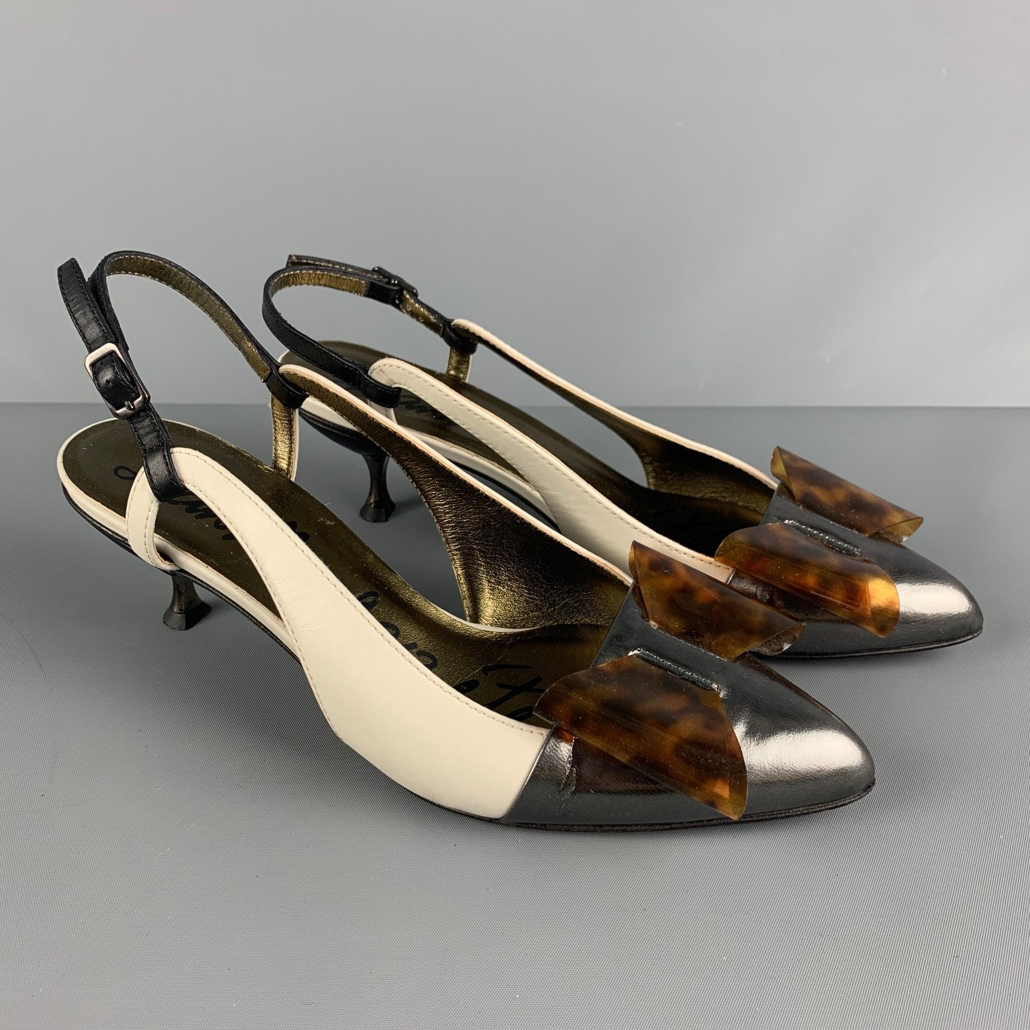 LANVIN pumps comes in a cream and silver leather featuring an acetate bow, and kitten heel. Made in Italy.Very Good Pre-Owned Condition. Moderate Wear. 
 

 Marked:  39 
 

 Measurements: 
  Heel: 2.5 inches 
 

  
  
  
 Sui Generis Reference: