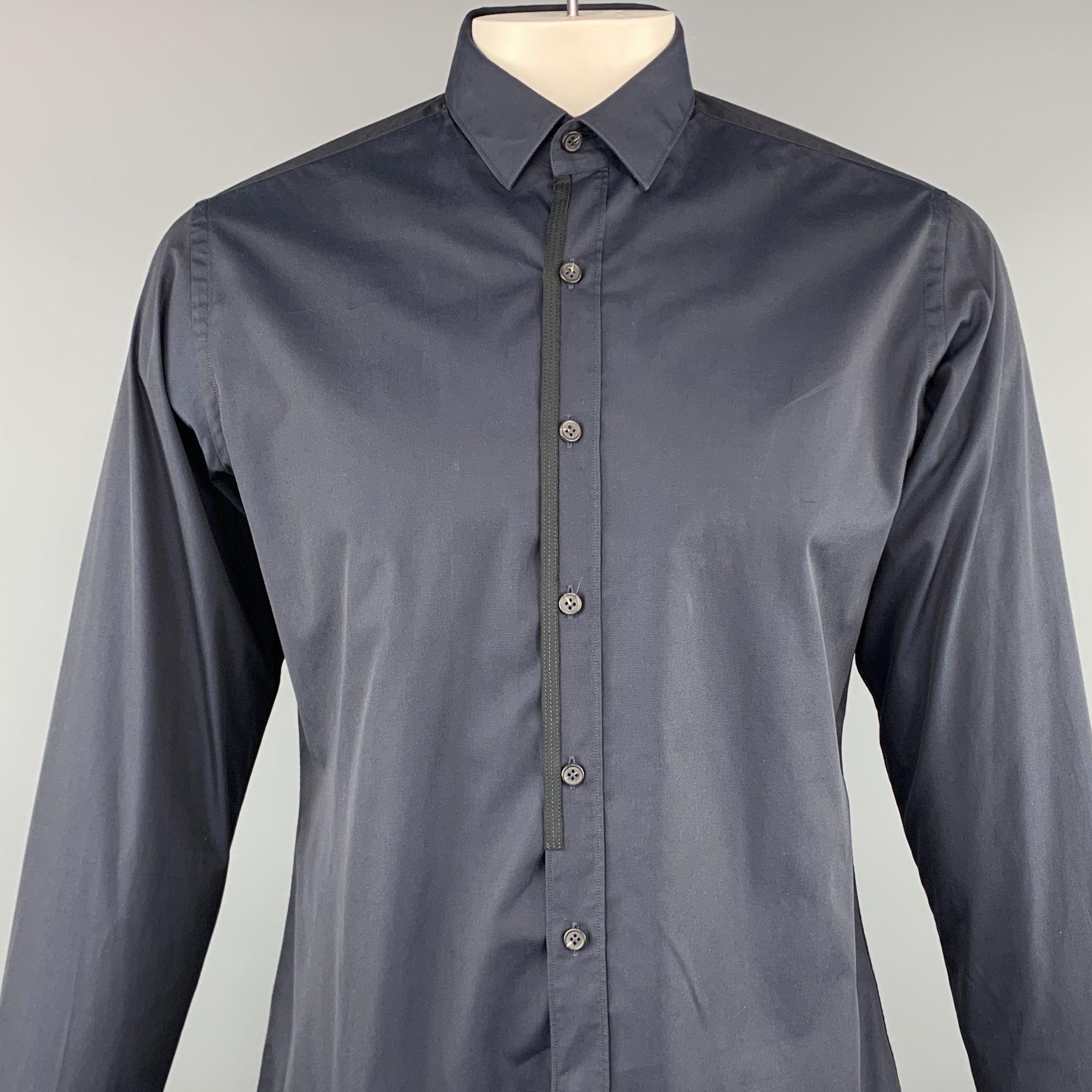 Lanvin long sleeve shirt comes in a navy cotton featuring a button up style, black trim, and a spread collar. Made in Italy.

Excellent Pre-Owned Condition.
Marked: 42/16.5

Measurements:

Shoulder: 17 in. 
Chest: 46 in. 
Sleeve: 27 in. 
Length: 25