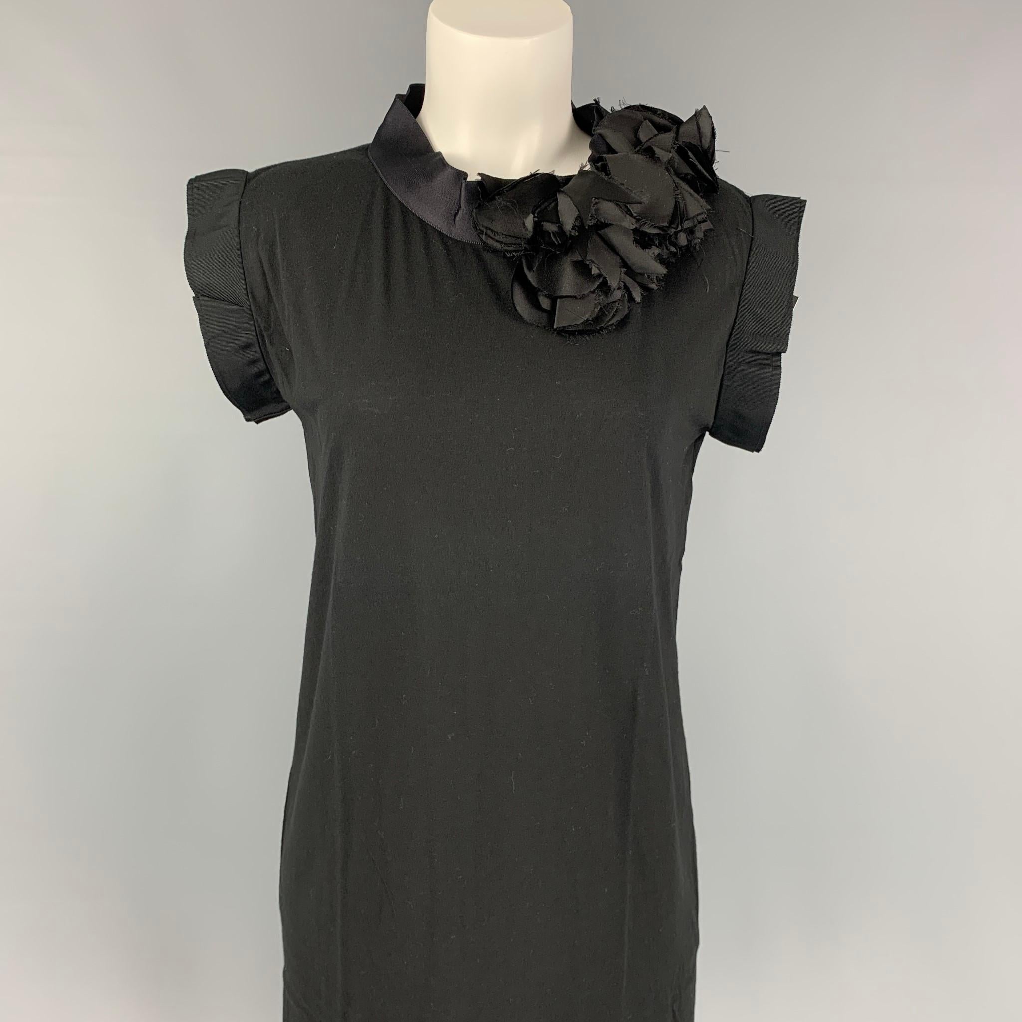 LANVIN dress comes in a black cotton featuring a shift style, sleeveless, ribbon trim, and silk flower details. 

Very Good Pre-Owned Condition.
Marked: Size tag removed.

Measurements:

Shoulder: 16.5 in.
Bust: 36 in.
Waist: 38 in.
Length: 37 in. 