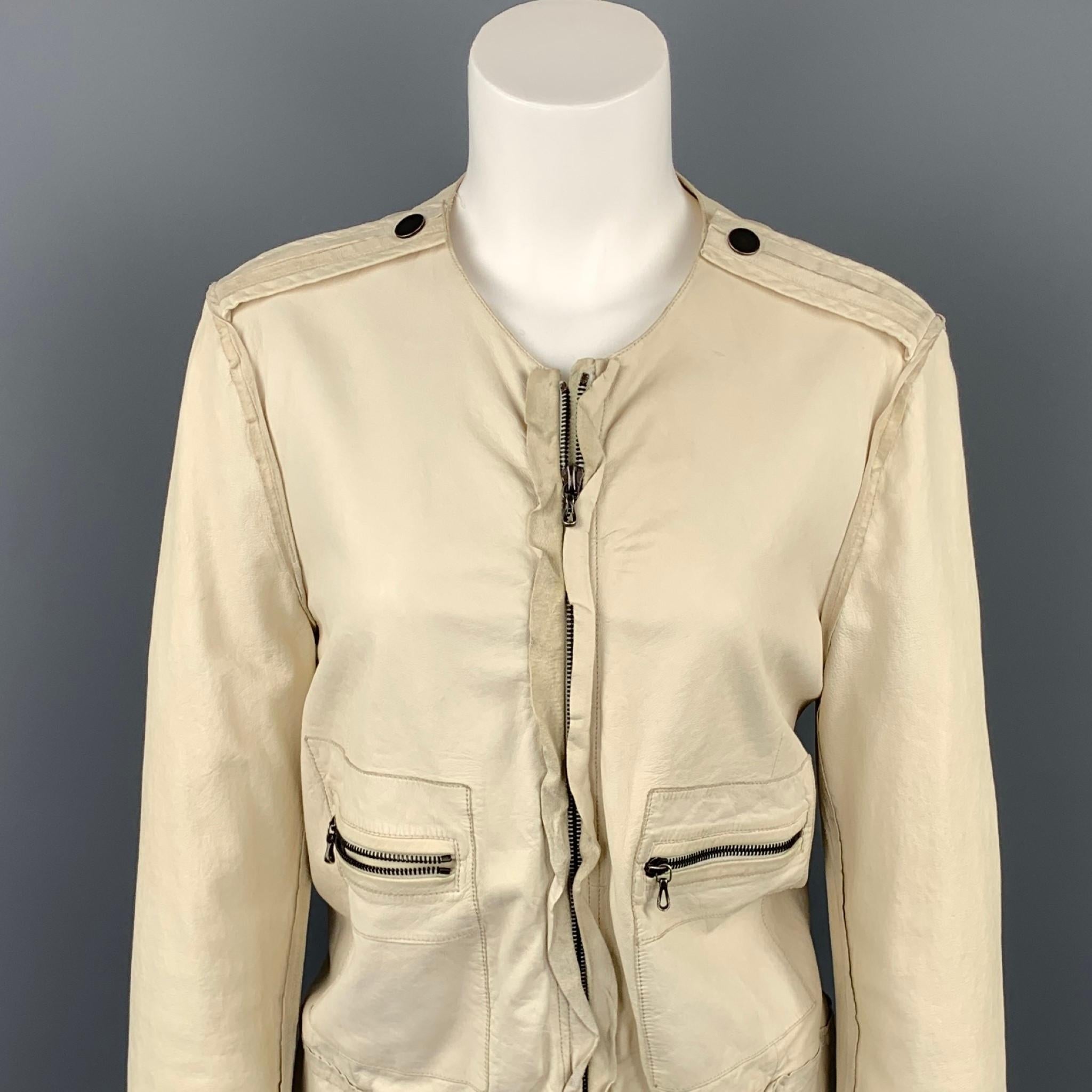 LANVIN Spring 2010 jacket comes in a off white leather and featuring a collarless neckline, epaulettes, zipper patch pockets, ruffled trim, and a zip up closure. Minor wear throughout leather. Made in Italy.

Good Pre-Owned Condition.
Marked: IT