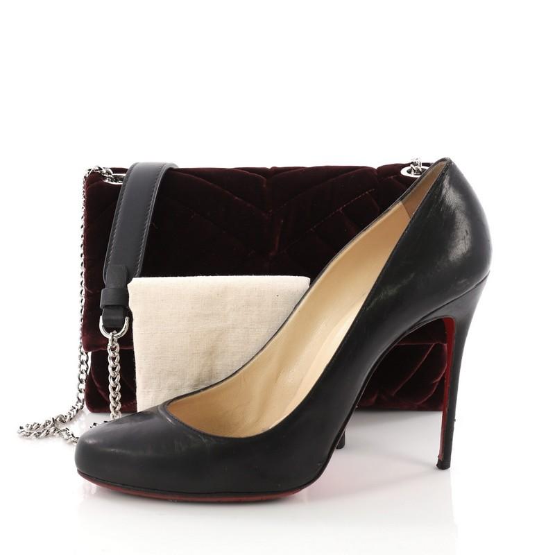 This Lanvin Sugar Flap Shoulder Bag Quilted Velvet Mini, crafted from burgundy quilted velvet, features a chain strap with shoulder pad and silver-tone hardware. Its hidden magnetic snap closure opens to a blue fabric interior divided into three
