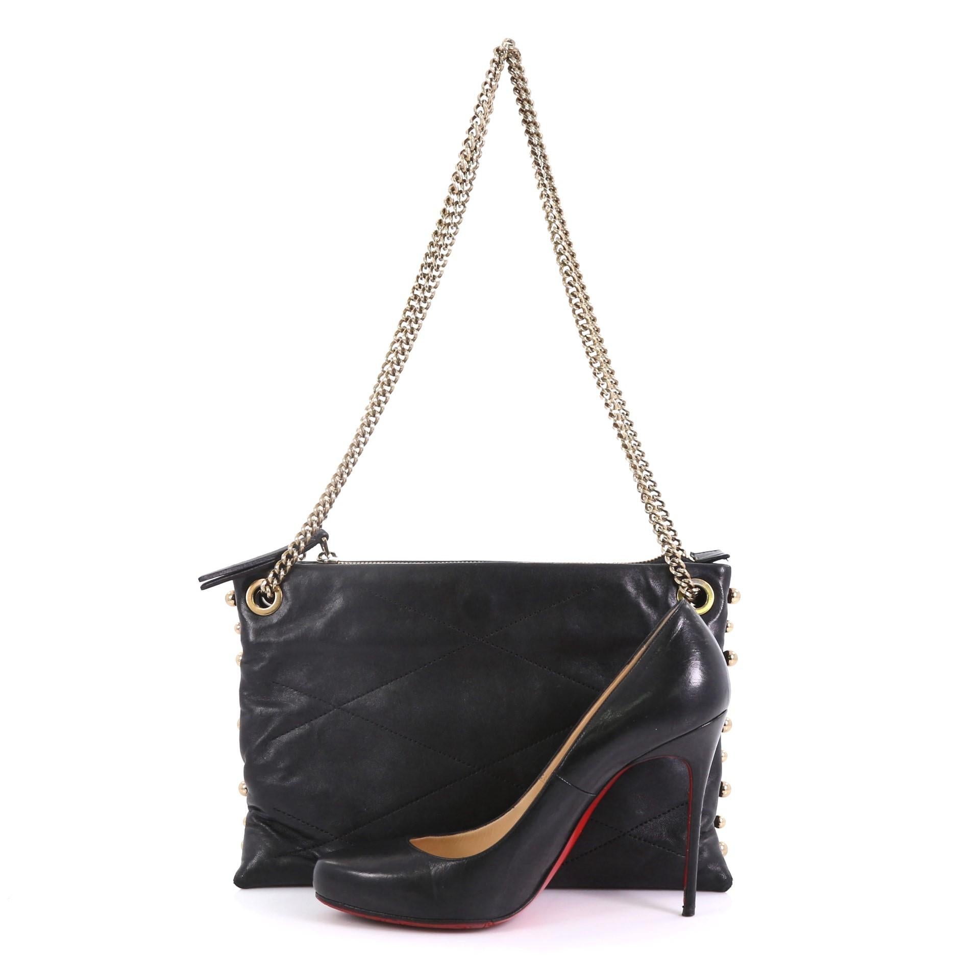 This Lanvin Sugar Shoulder Bag Quilted Leather Small, crafted from black quilted leather, features chain link strap, stud details, three compartments, and gold-tone hardware. Its middle zip closure opens to a gold fabric interior with zip pocket.