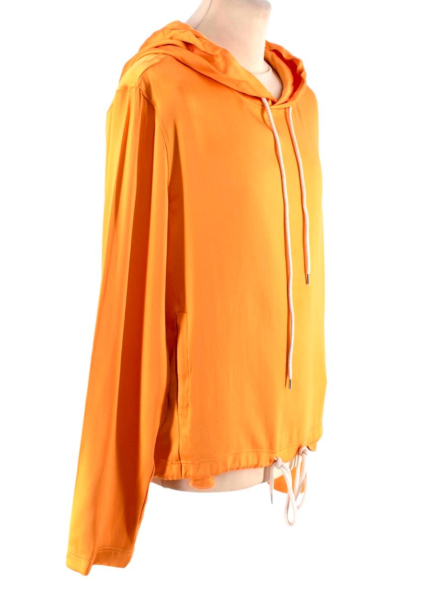 Lanvin Tangerine Silk Jersey Hoodie
 

 - Tangerine orange hue
 - Silk-blend
 - Lightweight
 - Cream drawstring hood, long sleeves, inset side pockets, and drawstring hemline 
 

 Materials 
 45% Silk 
 55% Viscose 
 

 Made in Italy 
 Dry Clean