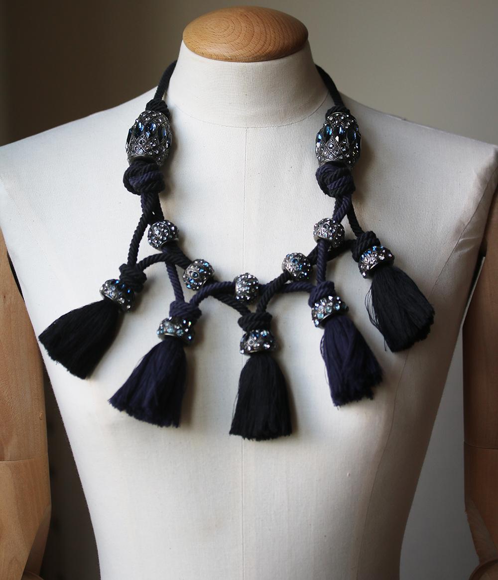 Black and blue cotton, glass, brass and pewter tassel necklace from Lanvin featuring crystal embellishments, multi-faceted stone embellishments and a lace fastening. Material: Pewter/glass/Brass/Cotton. Color: blue. Comes with original