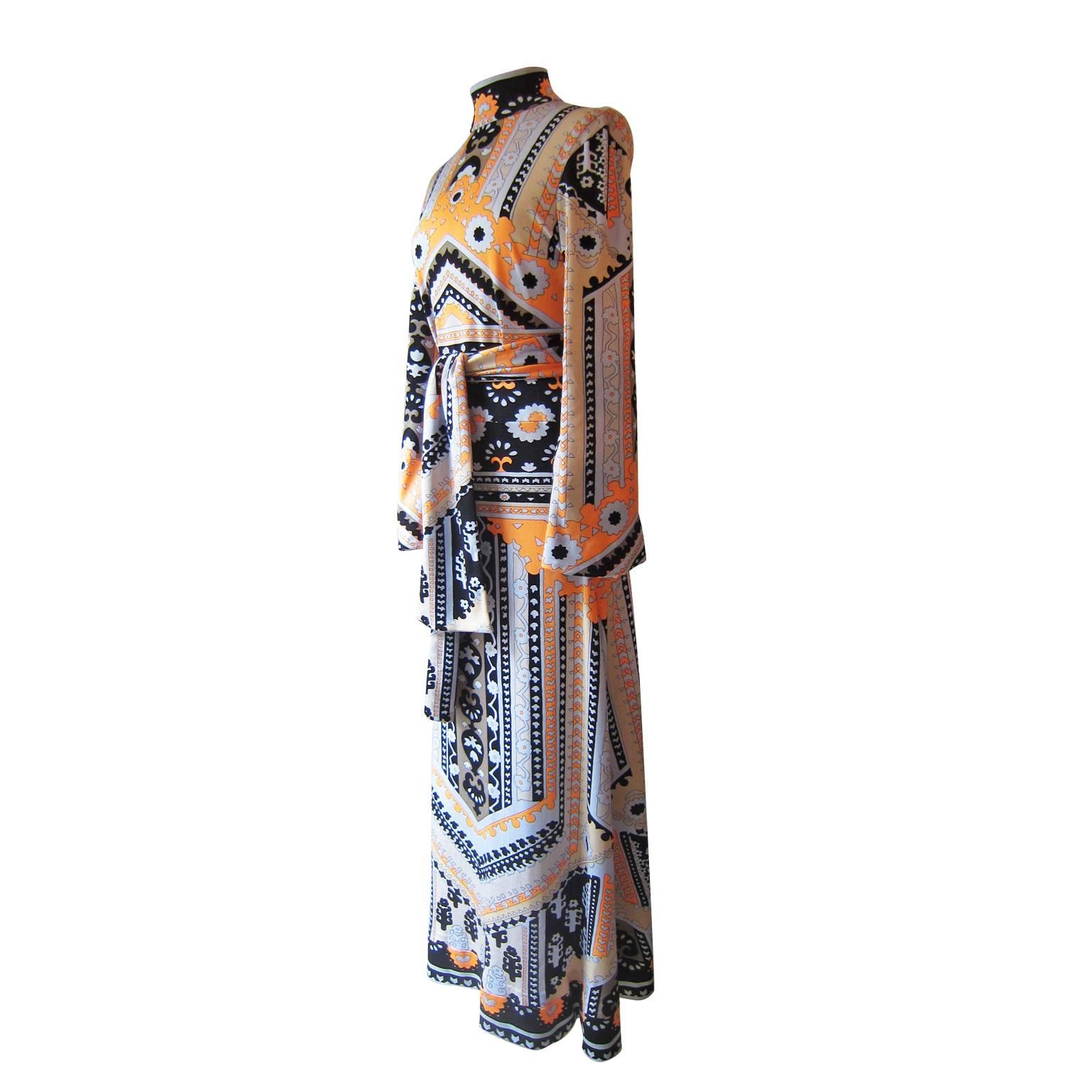 Lanvin graphic dress with tie belt from 1970s.
The dress has a high neckline, long sleeves and a back zipper closure. 
The stunning colour graphic balance and range prints is held in striking bold colours of orange, light grey, golden beige and