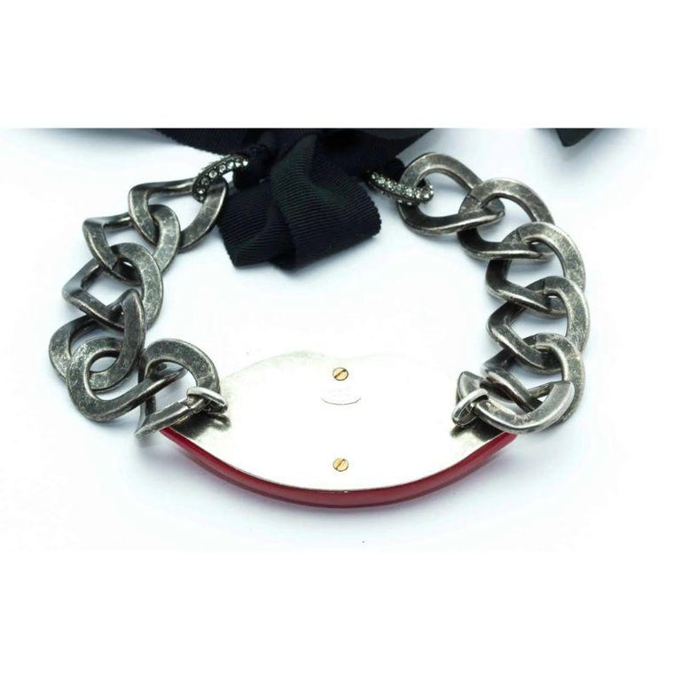 Rare Collectable surreal Lanvin vintage lip necklace c.2010 made of red resin, cristal stones, gun metal and black coton adjustable string. 

Signature: Lanvin Paris made in France
Dimensions: lenght of the metallic part: 29 cm - width - 4 cm.