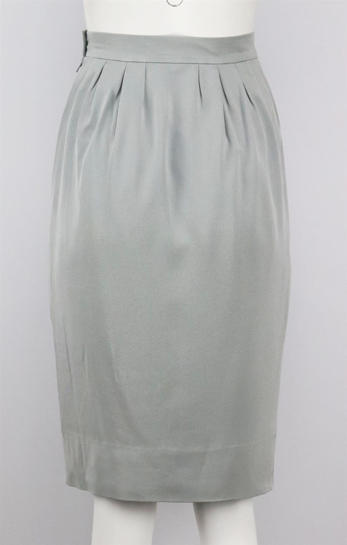 This vintage skirt by Lanvin is cut from metallic-grey silk, it has structured ruched detail along the waist to accentuate the flattering fluted shape. Grey silk. Button and zip fastening at side. 100% Silk; lining: 100% silk. Size: FR 40 (UK 12, US