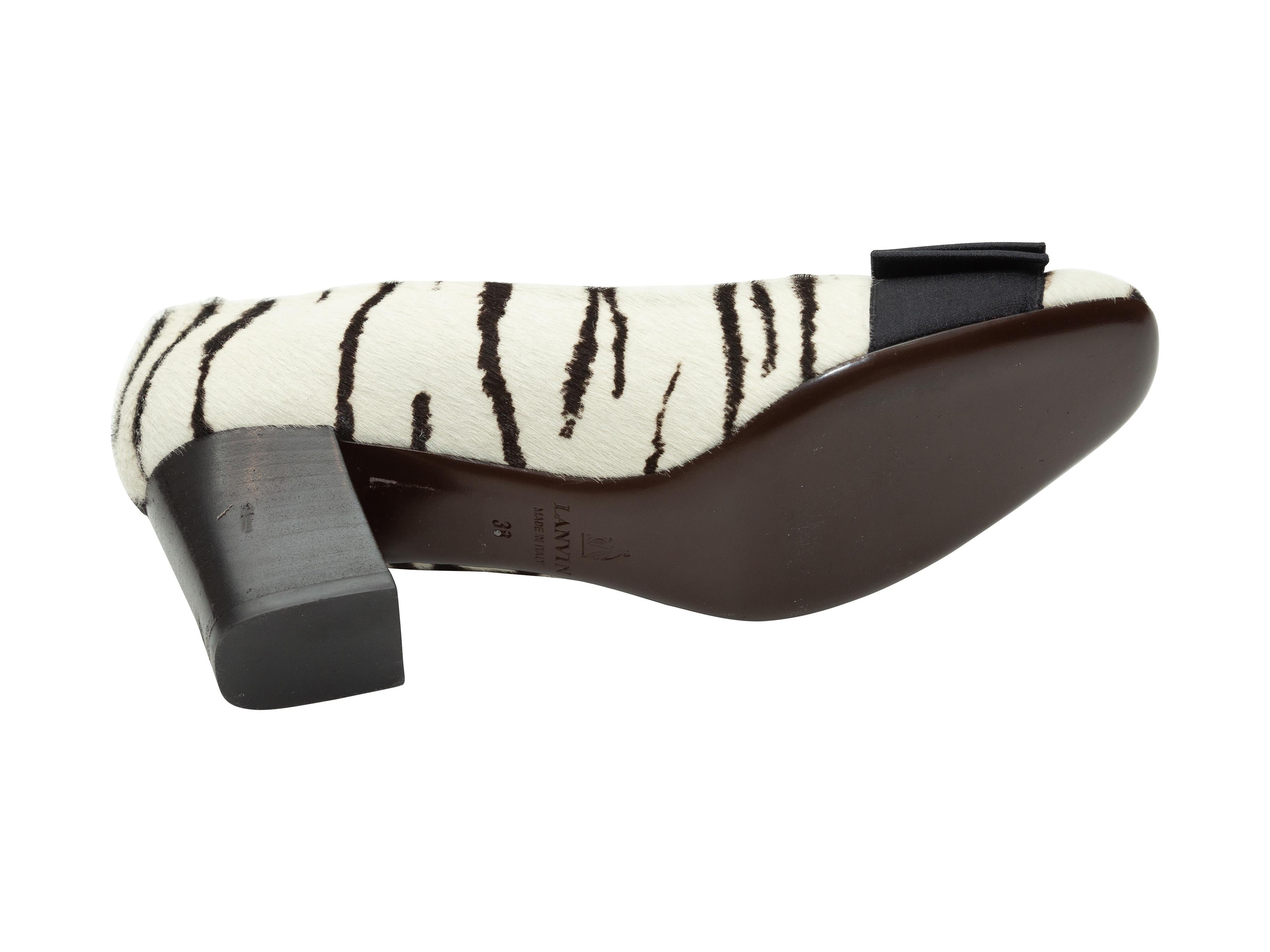 Product details: White and black round-toe ponyhair pumps by Lanvin. From the Fall/Winter 2013 Collection. Zebra print throughout. Bow accents at toes. Stacked heels. Designer size 38. 2