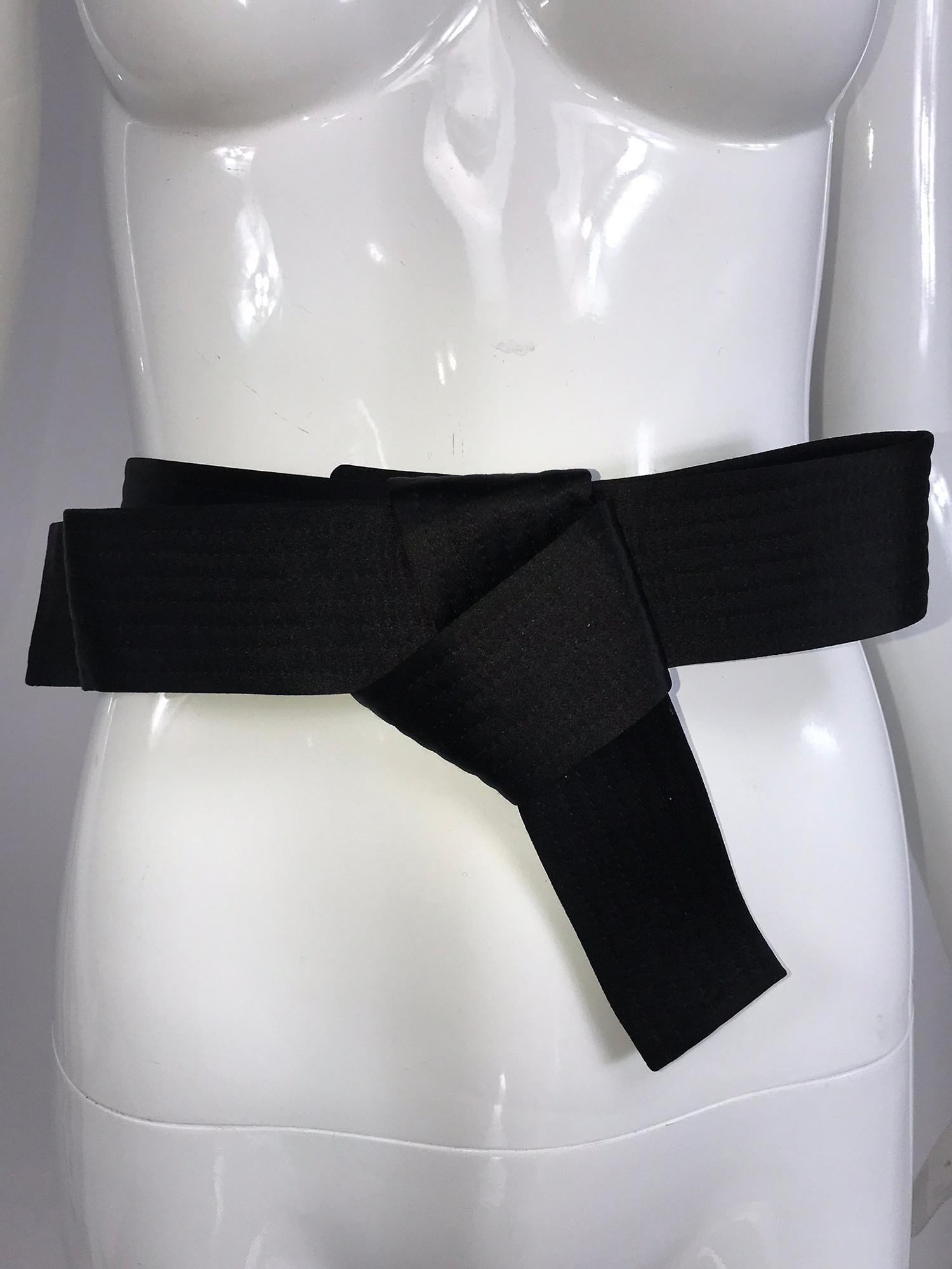 Lanvin wide horizontally quilted black belt in satin with a bow. Worn once, this belt comes with the box and tags. The belt will add the final touch to a special outfit or dress. In excellent condition. The belt adjusts and closes with hidden hooks