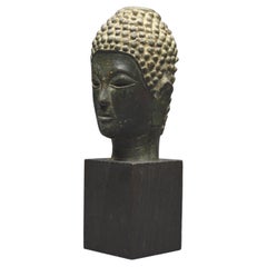 Laos, 16th - 17th Century, Small Bronze Buddha head with green patina