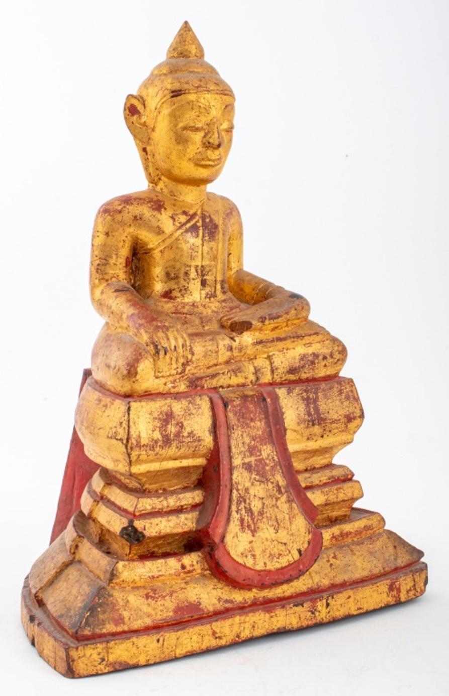 Antique Laos hand-carved and gilt lacquered wood sculpture depicting the enlightened Buddha figure seated atop a tiered base. Provenance: From the collection of Le Lieu and Malcolm Browne (American, 1931-2012), the photojournalist who took the 1963