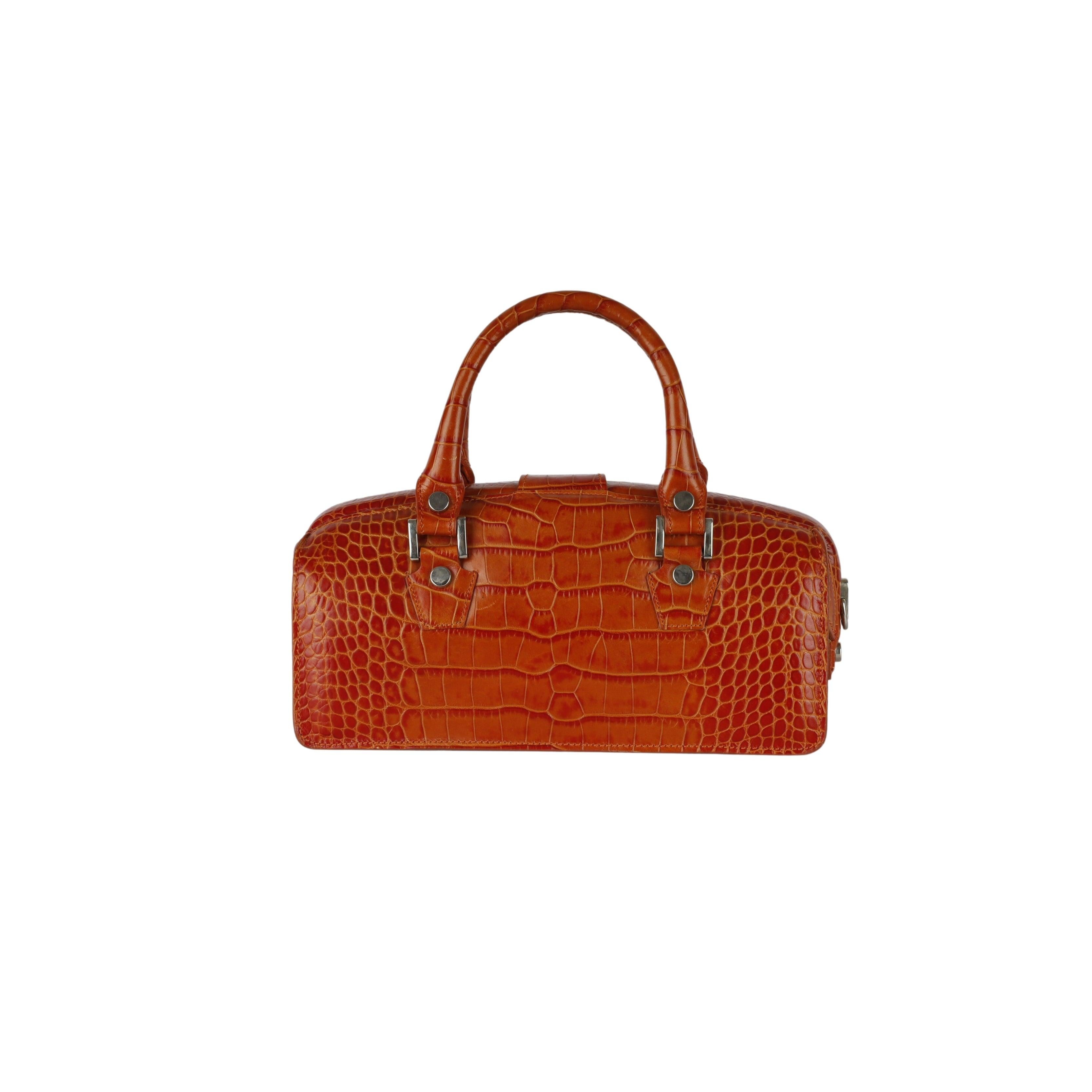 This L.A.P.A. Vintage Croco Handbag is made from high-quality brick toned crocodile embossed leather, with a secure top handle and a buckle strap with a clasp for secure opening. It also comes with a key to lock the bag, plus a soft leather lining
