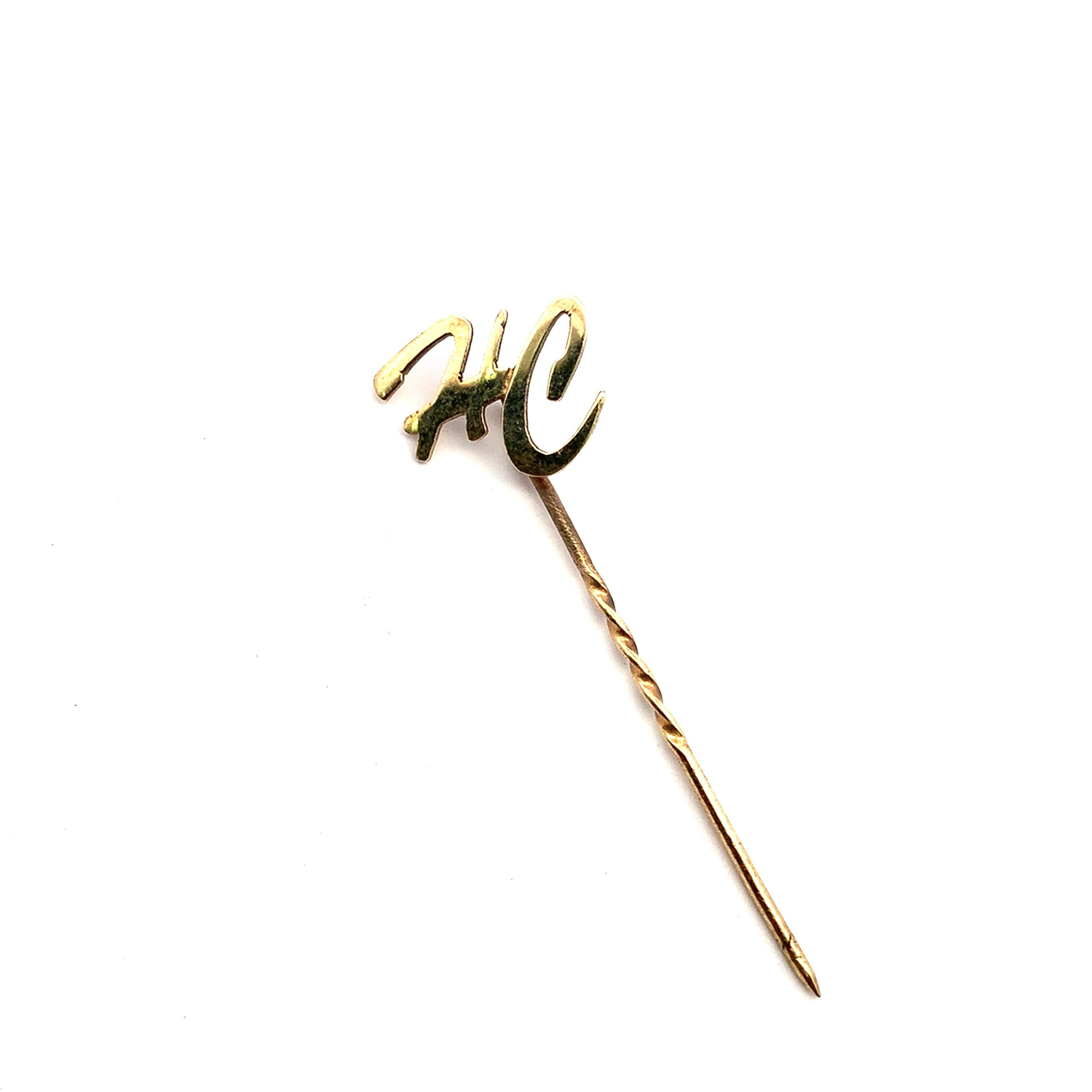 Elevate your style with this minimalist 9ct solid gold HC initial pin. The delicate twist of the pin adds a unique touch. A statement of personal expression, it is a subtle yet powerful accent, suitable for adorning lapels, collars, or bags.