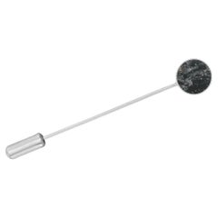Lapel pin with grey stone loellingite silver